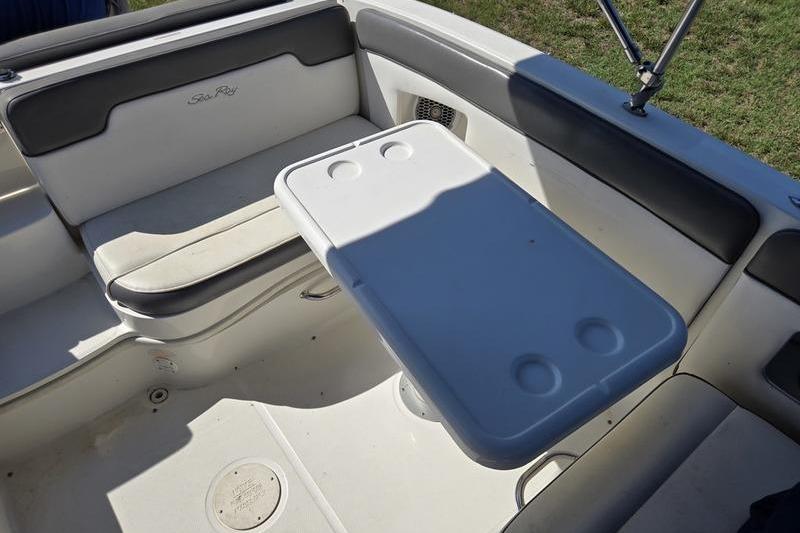 Interior of 2011 Sea Ray 300 Sundeck with seating and table setup.