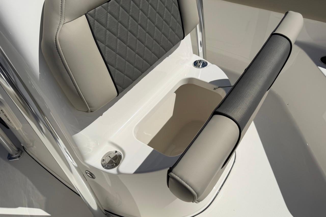 2026 Key West 203 FS boat seat with storage compartment, featuring gray and beige upholstery.