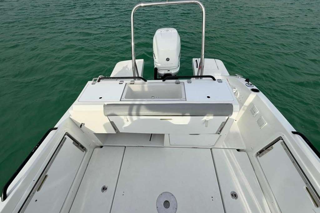 2019 Lagoon 630 MY yacht deck with motor, on calm green water.