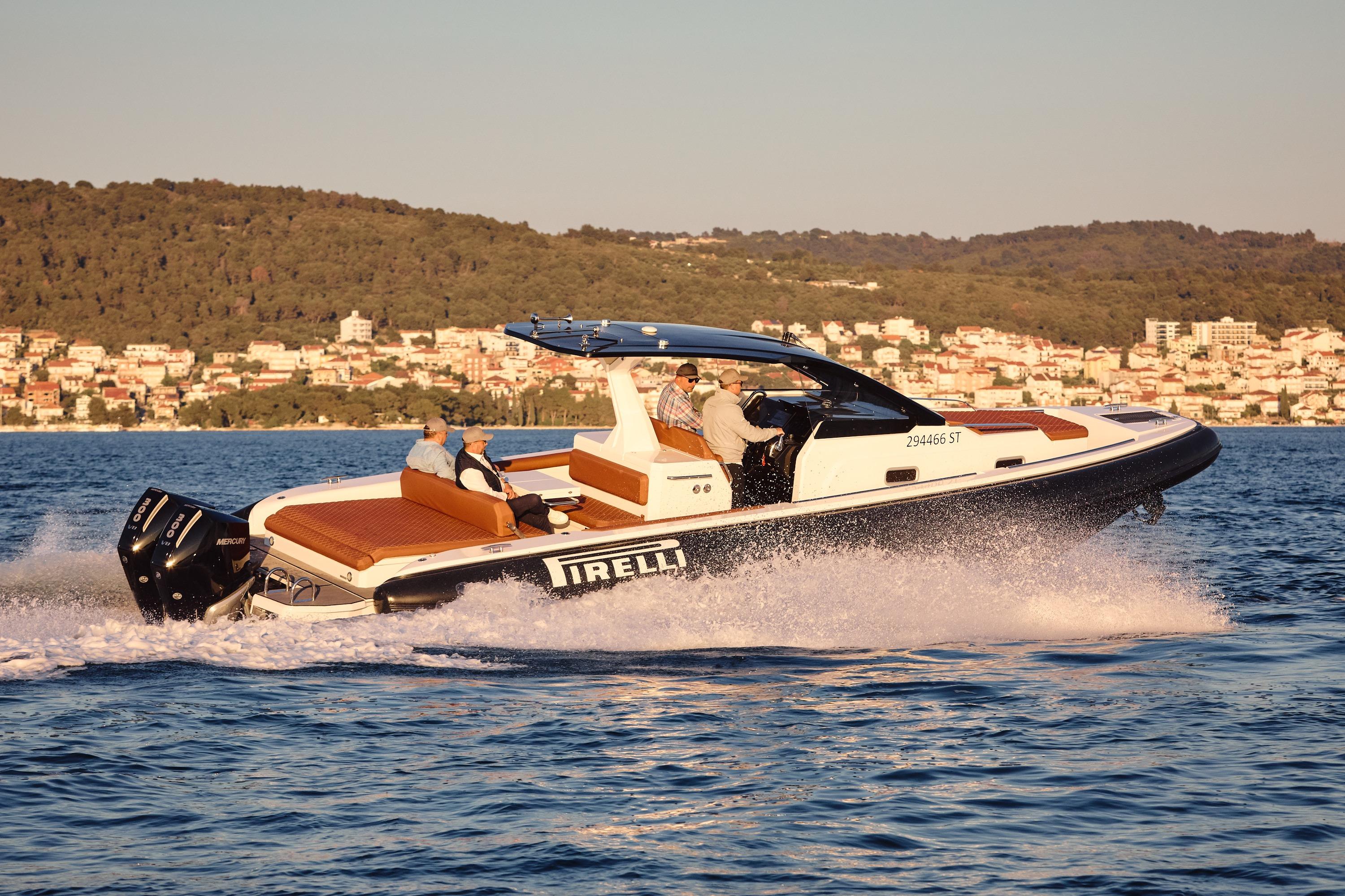 2025 Pirelli 35 boat cruising on water with scenic coastal backdrop.