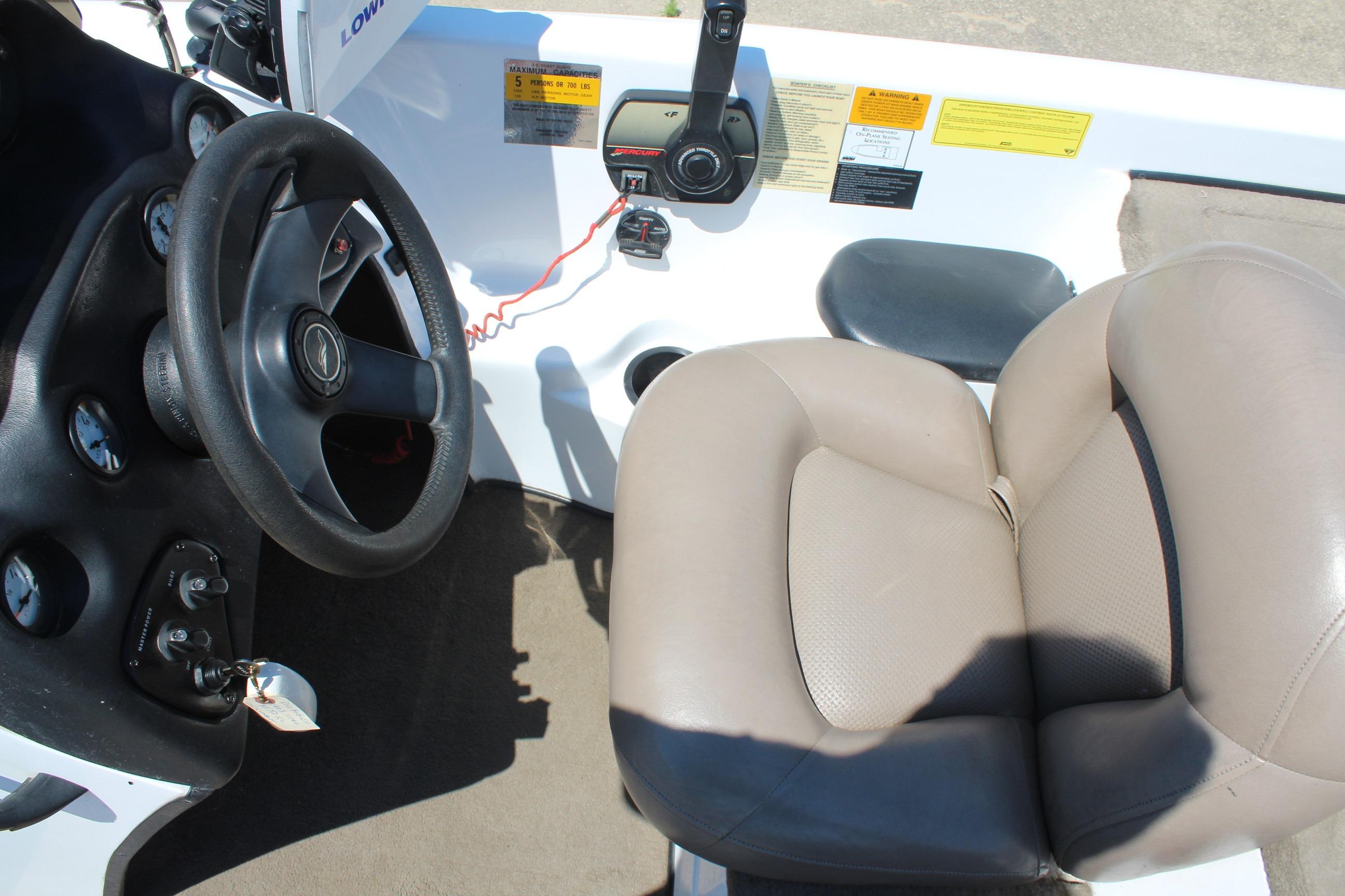 2003 Nitro NX 750 SC boat interior with steering wheel and beige seat.