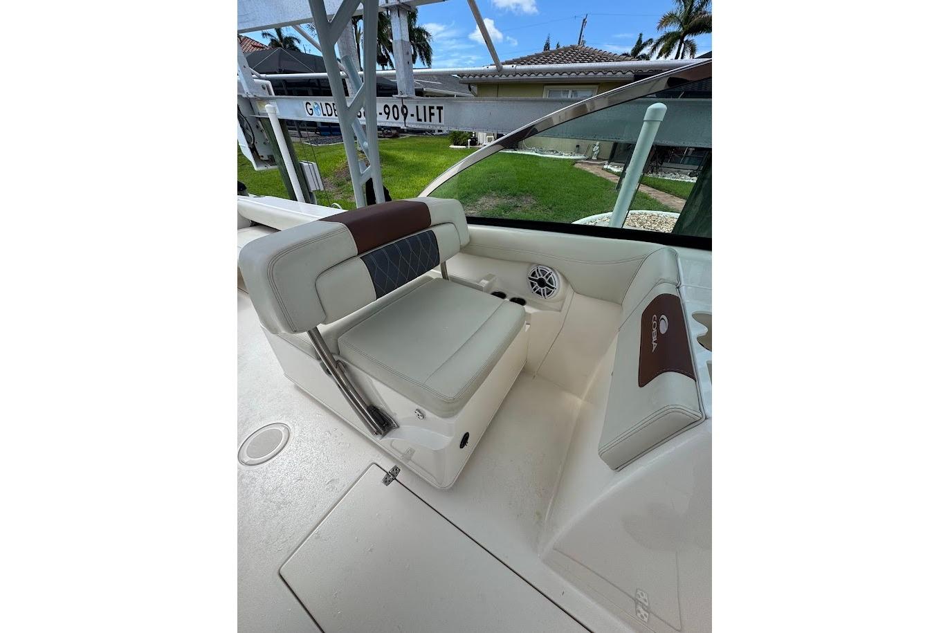 2020 Cobia 280 Dual Console boat interior with cushioned seating and speaker.