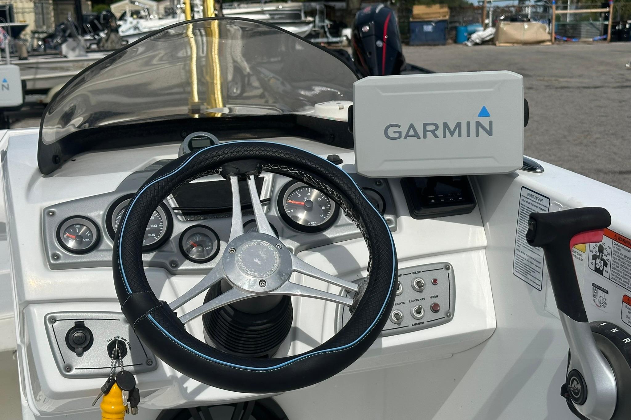 Steering console of 2021 Tahoe 2150 boat with Garmin navigation system.