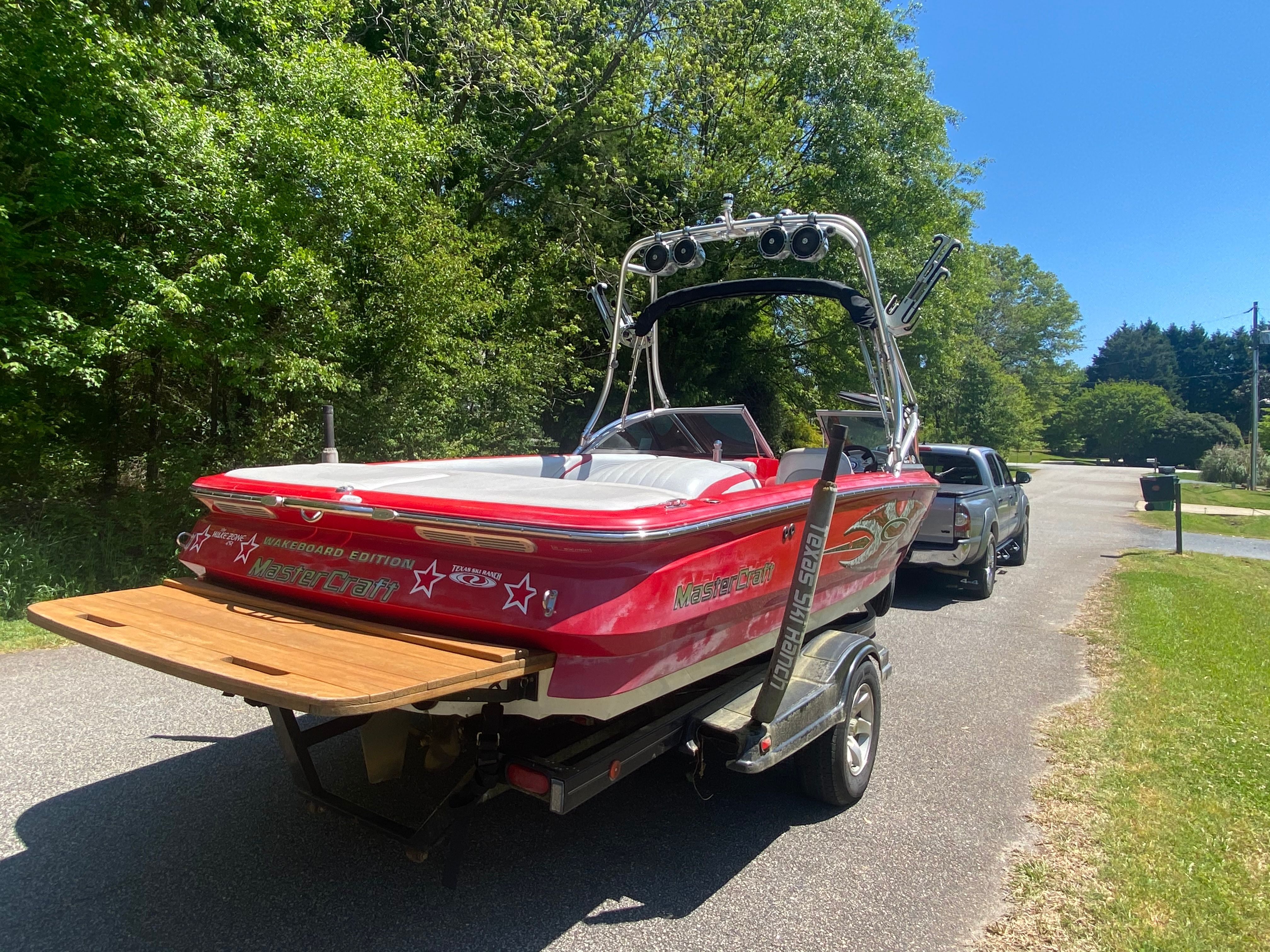 A red 2004 MasterCraft X-9 boat on a trailer, ready for water sports.