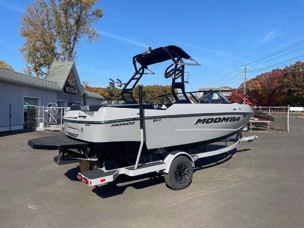2025 Moomba Mondo boat on trailer, parked outdoors under clear blue sky.