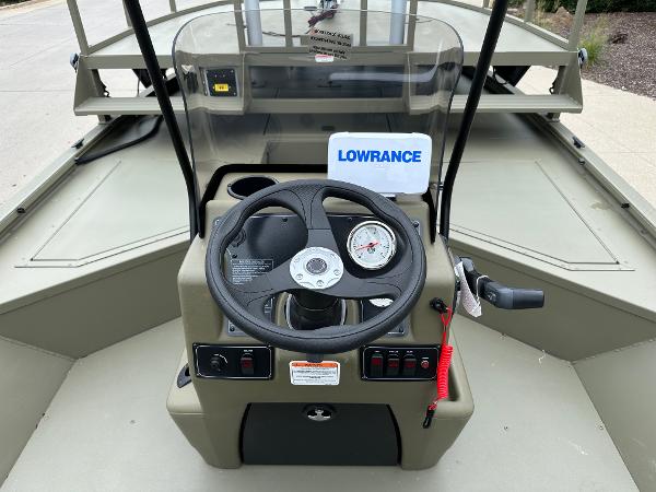 2025 Tracker Grizzly 2072 CC Sportsman boat dashboard with steering wheel and Lowrance device.
