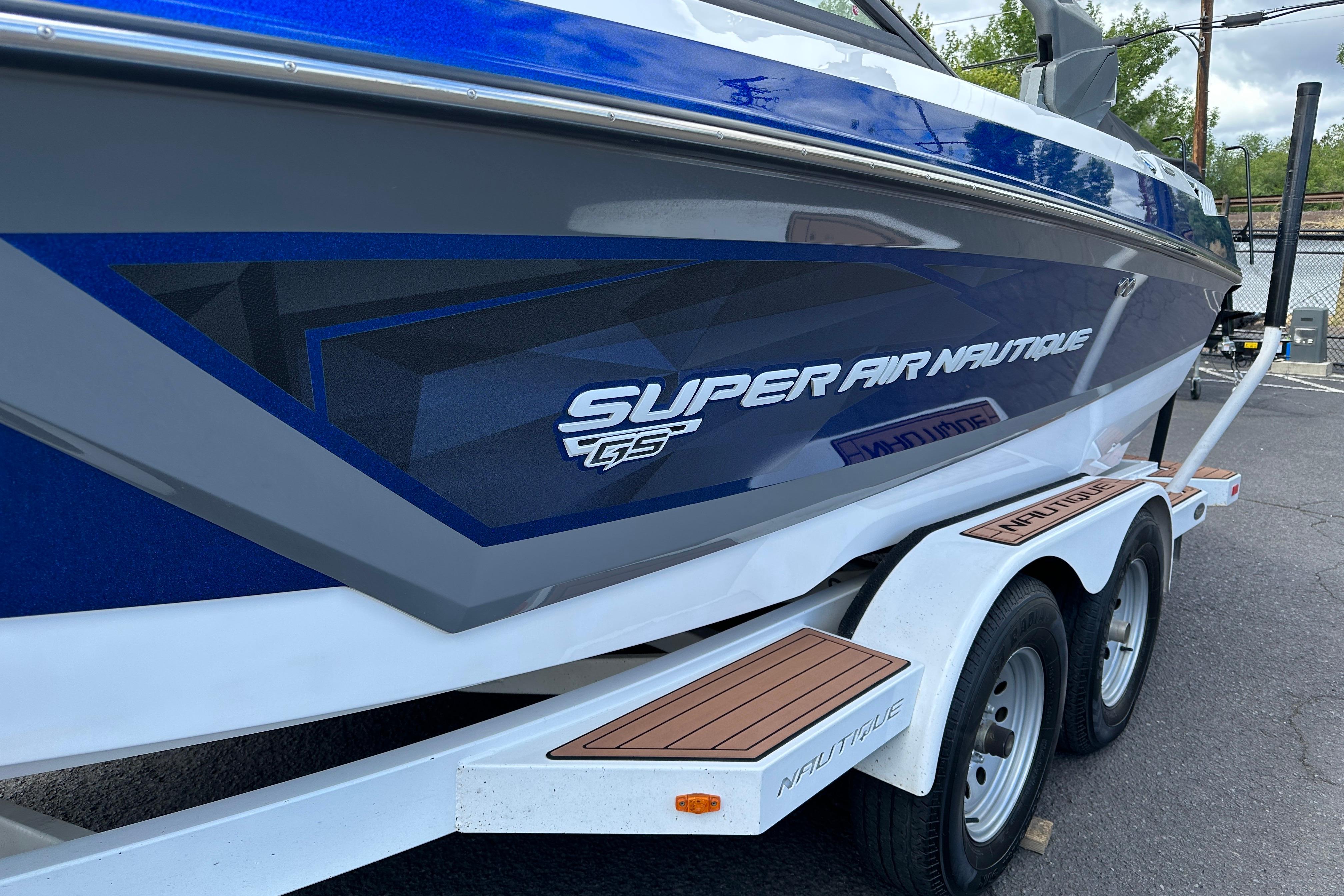 2017 Nautique Super Air Nautique GS20 boat on trailer, side view.