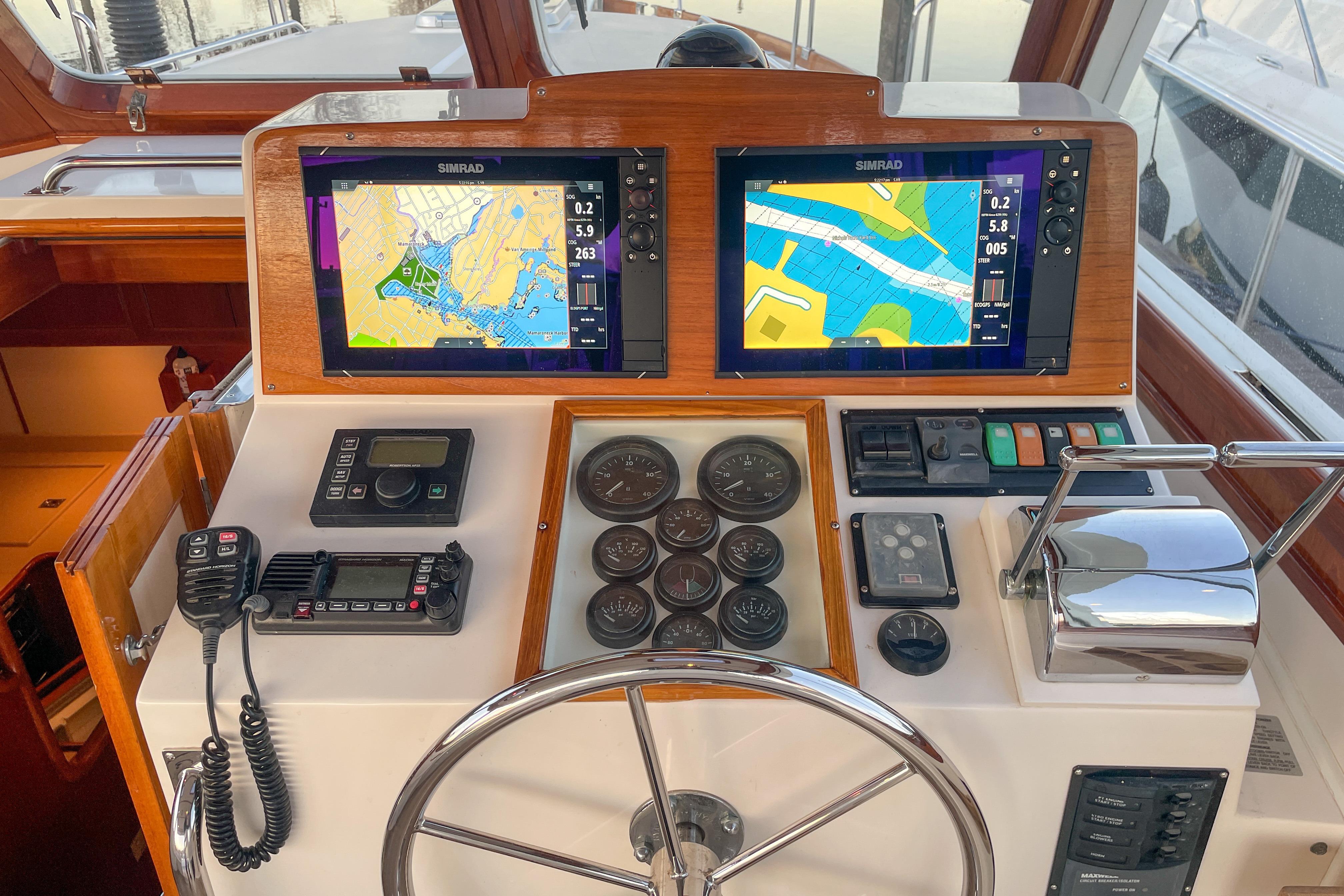 Helm of 2001 Grand Banks 38 Eastbay HX with navigation screens and controls.