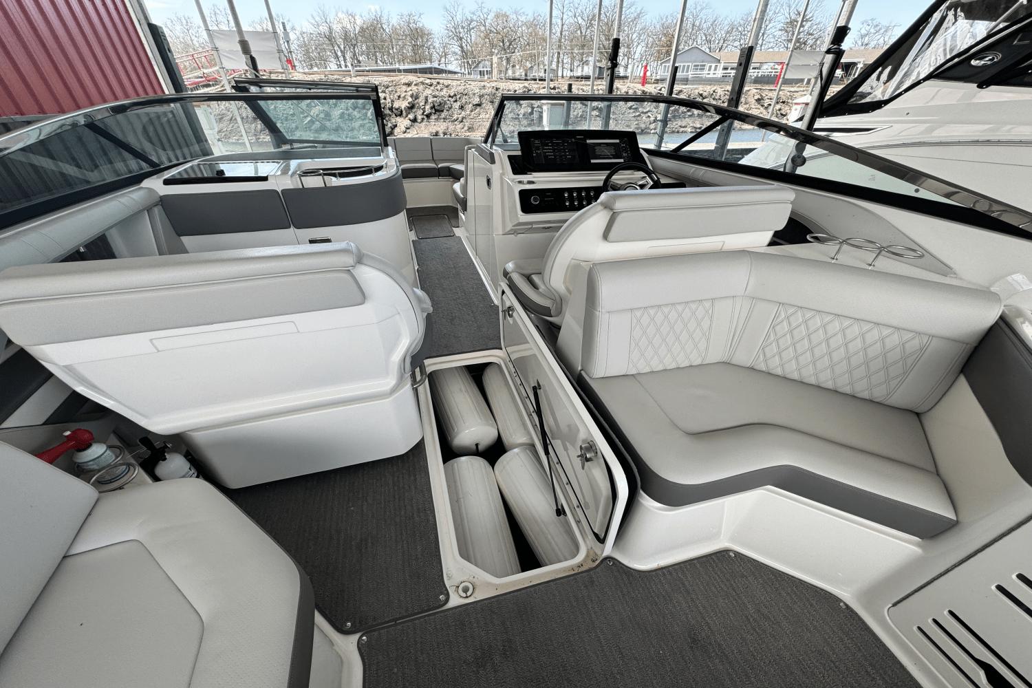 Interior of 2021 Sea Ray 310 SLX boat with luxurious seating and storage compartments.