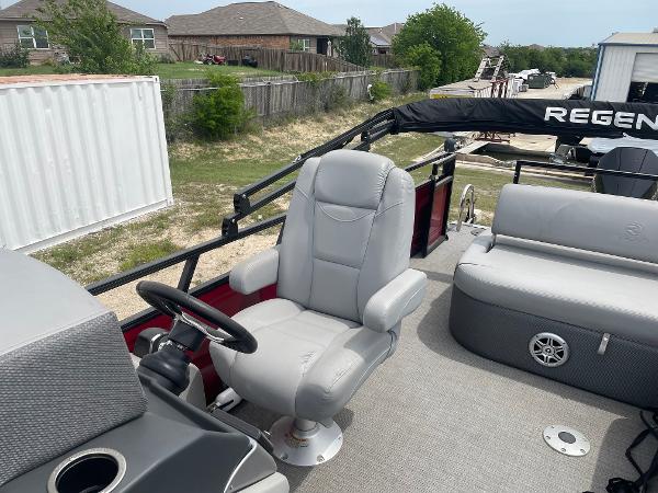 2023 Regency 250DL3 pontoon boat with plush seating and steering console.