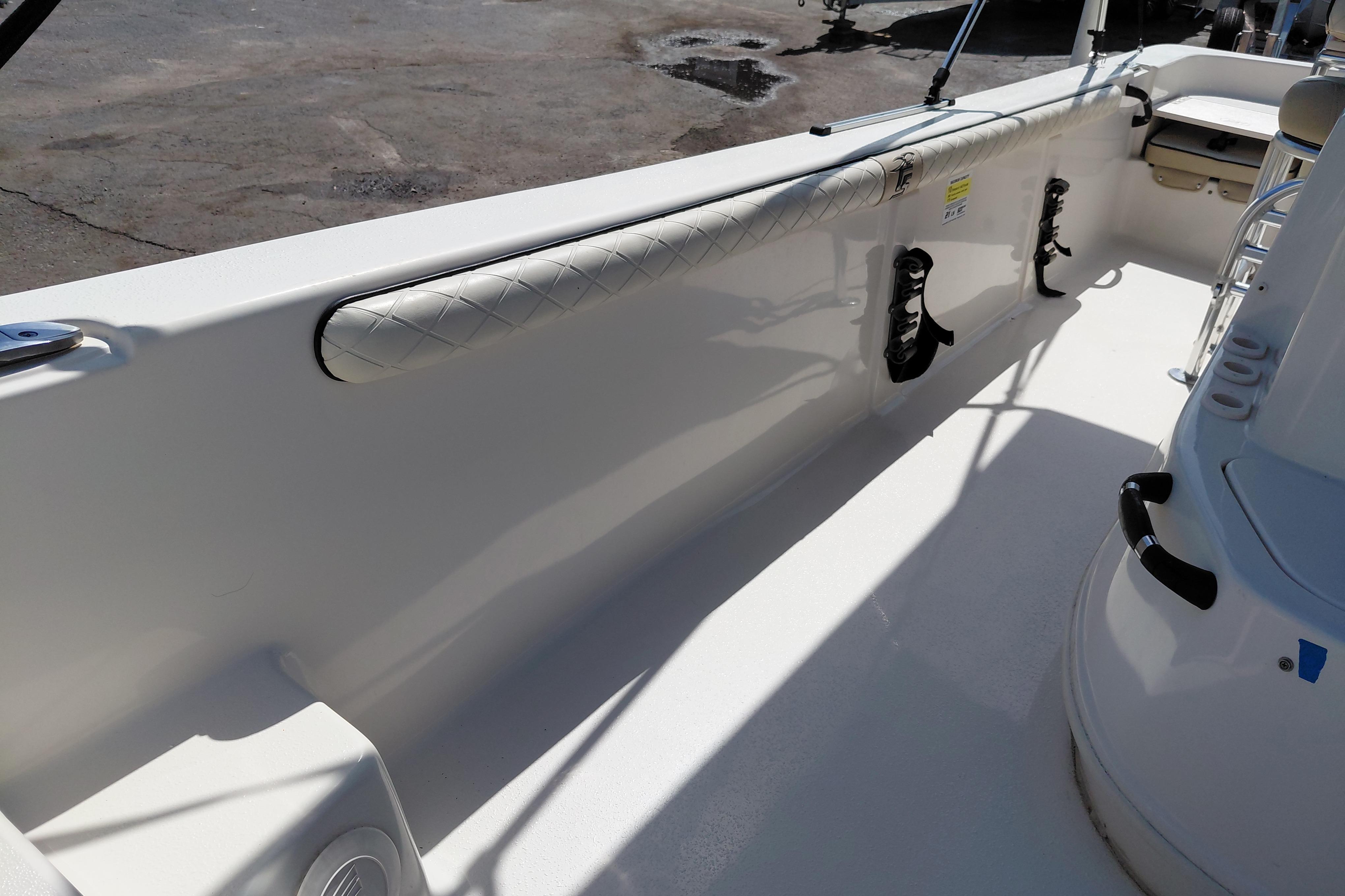2021 Carolina Skiff 21 LS boat interior with padded side rail and rod holders.