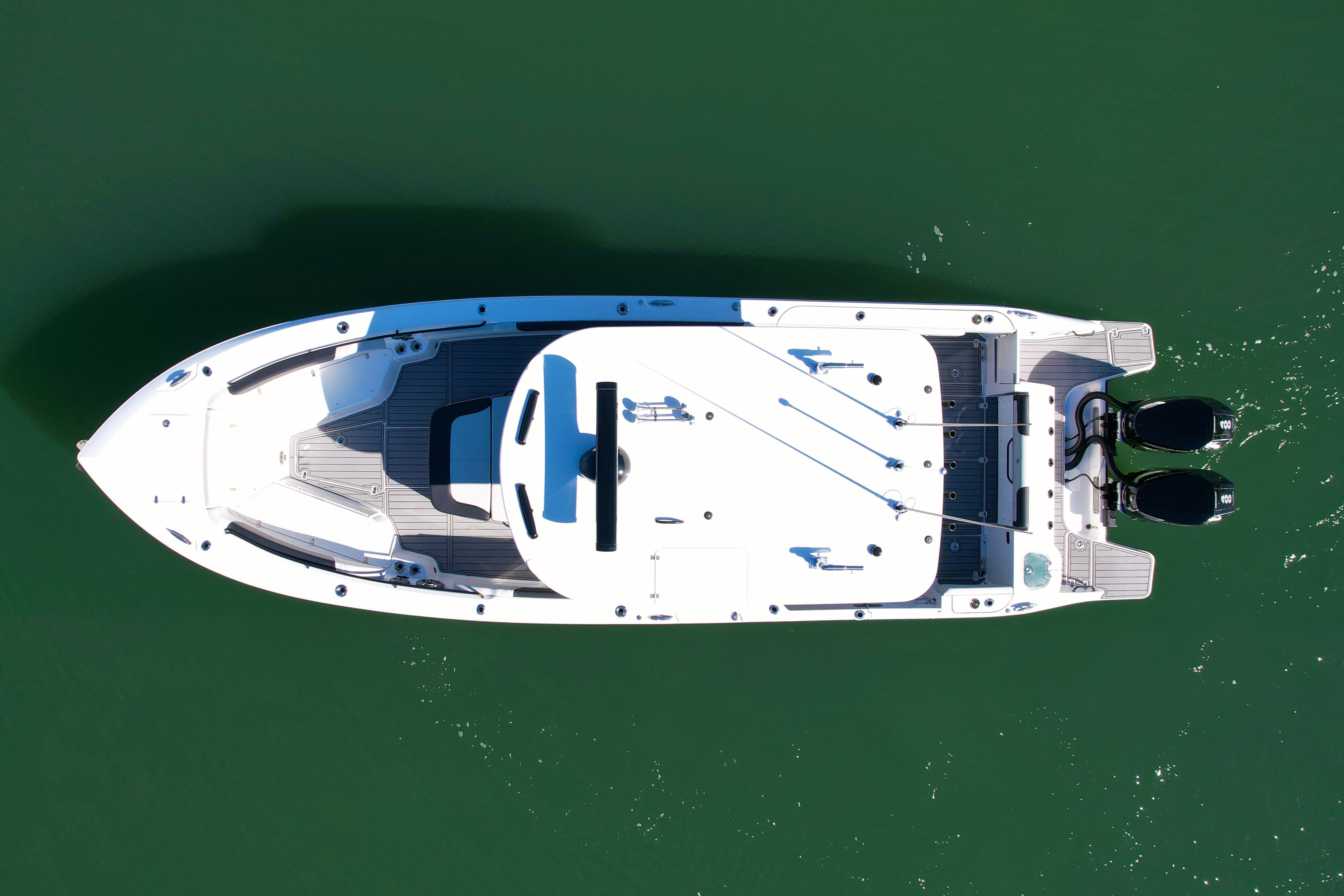 Aerial view of 2026 Edgewater 340CC boat on calm green water.