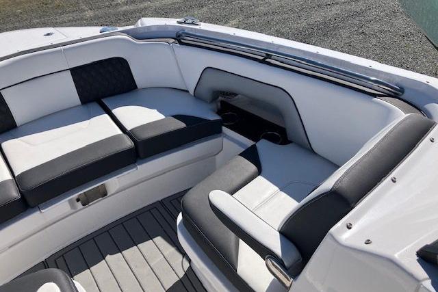 Luxurious seating area on 2024 Monterey M-65 boat with sleek black and white upholstery.