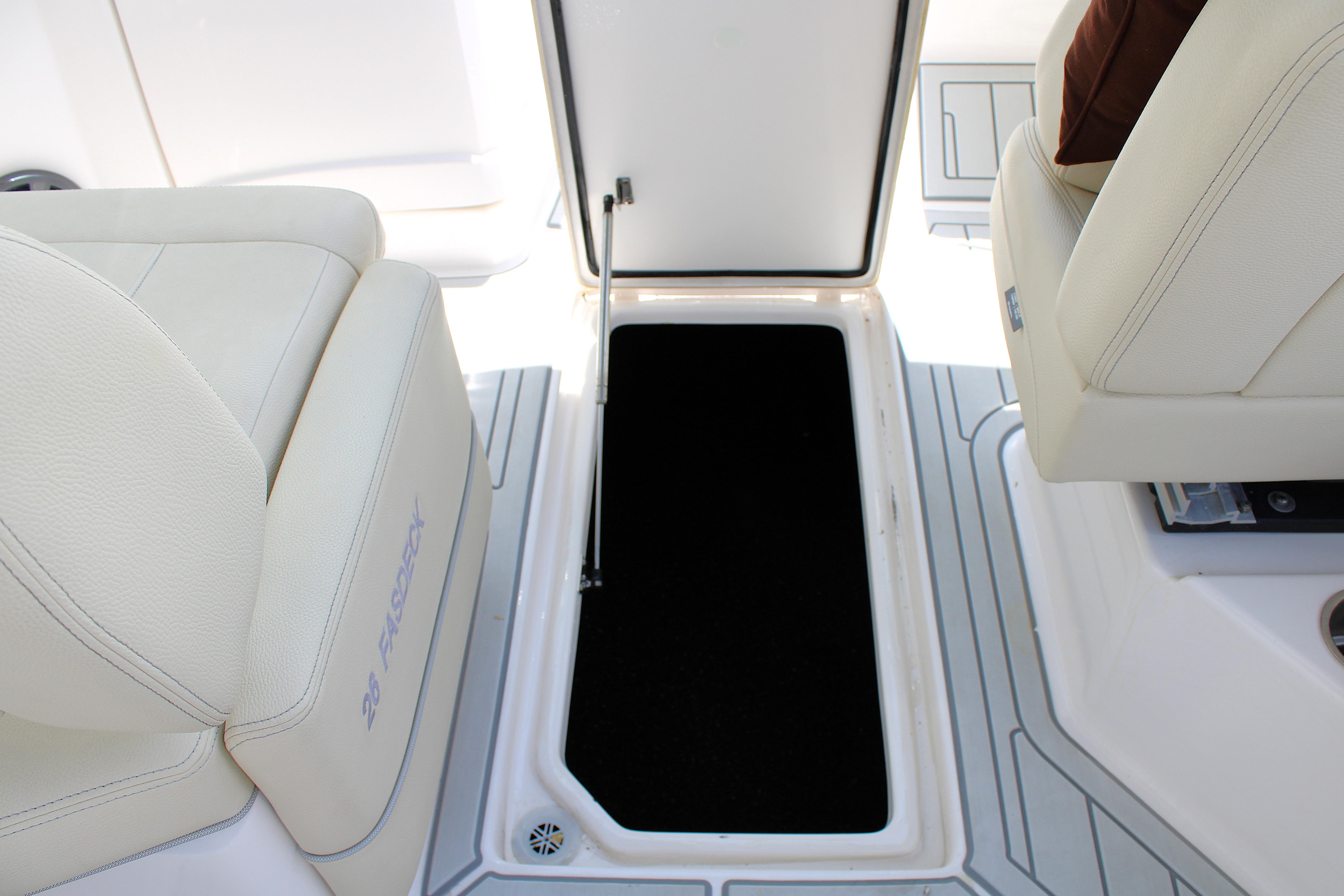 2021 Regal 26 OBX boat interior with open storage compartment and cushioned seating.