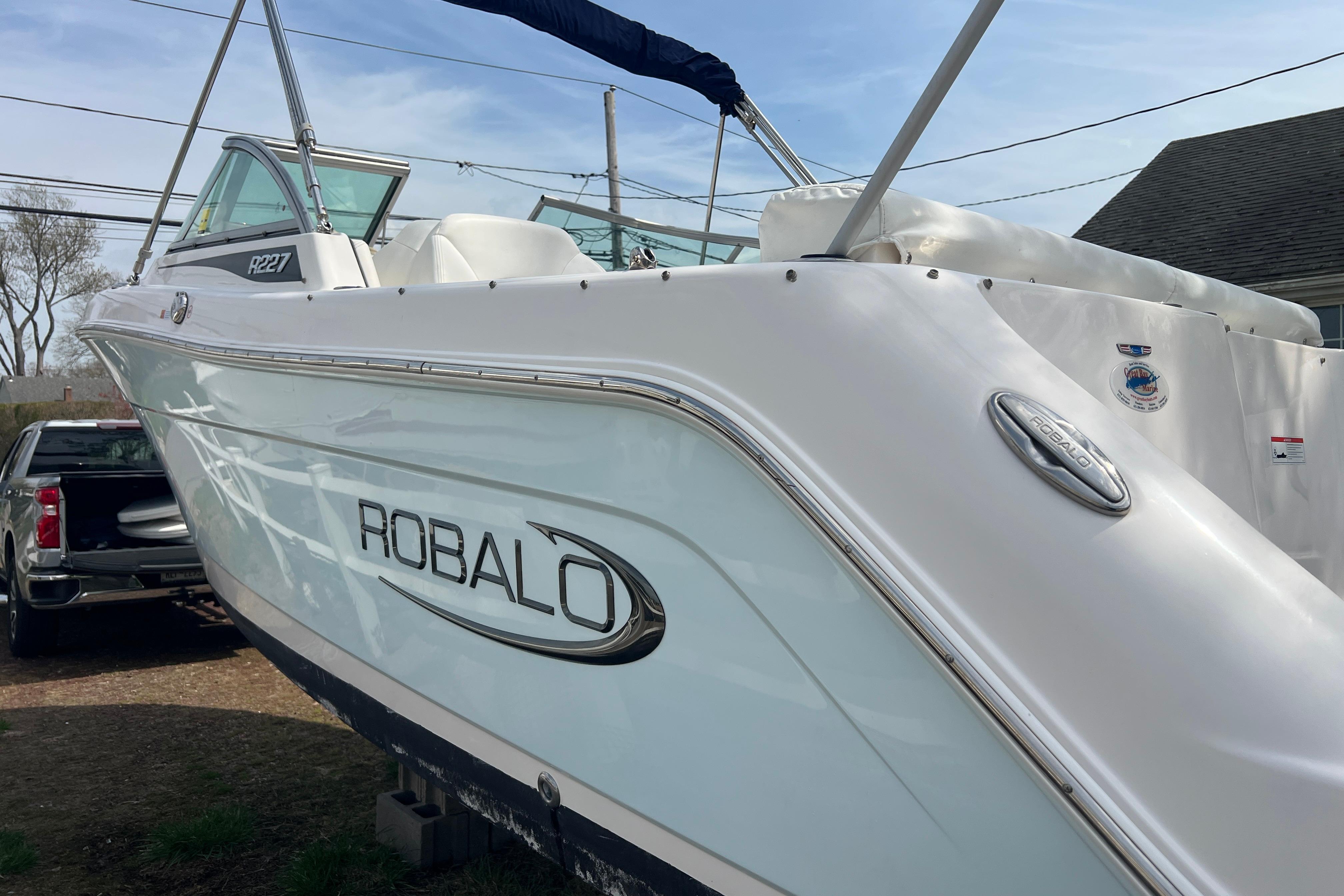 2022 Robalo R227 Dual Console boat, white exterior, parked outdoors.