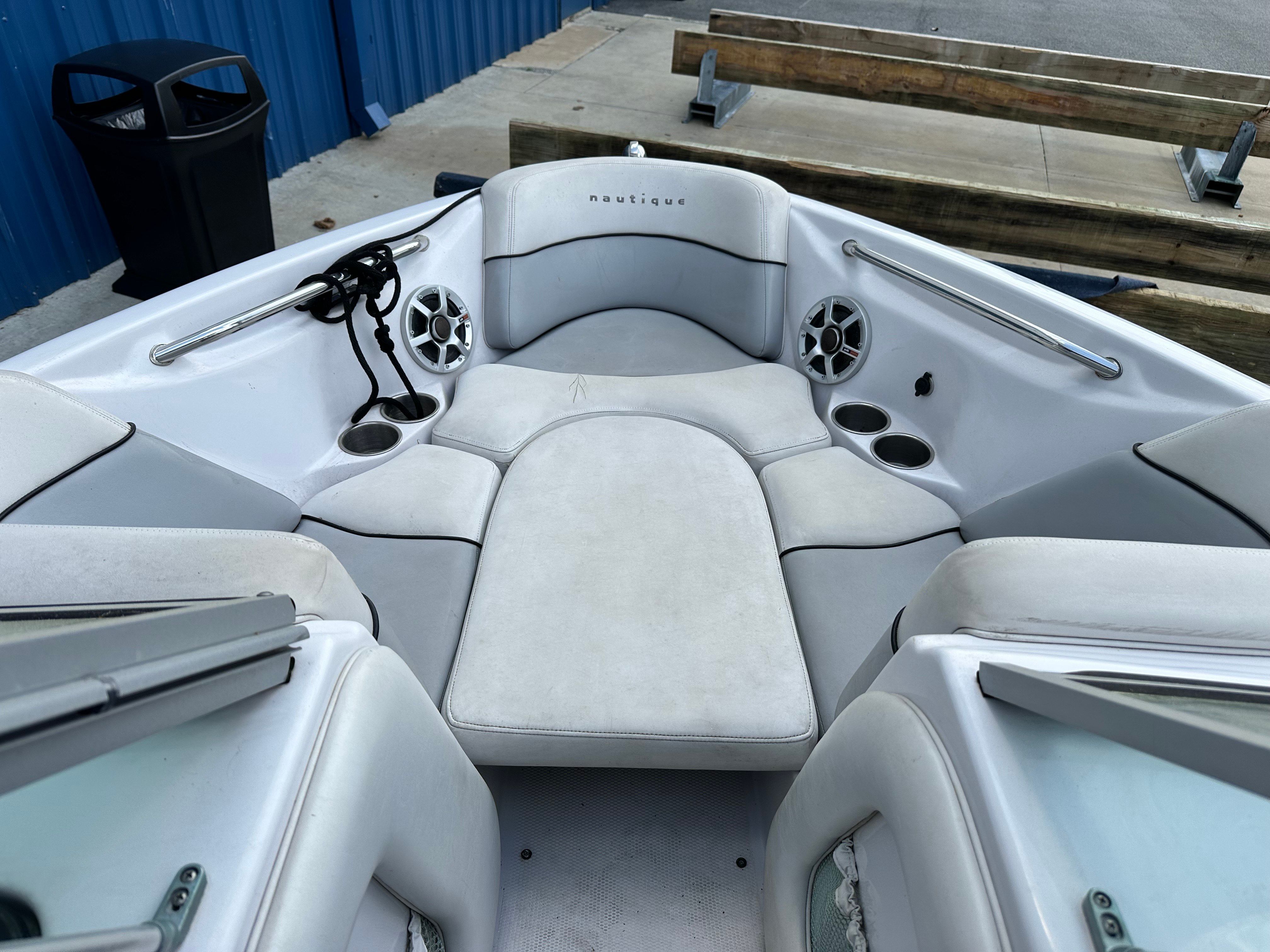 The image shows the bow area of a 2007 Nautique SV 211 with white upholstery and speakers.