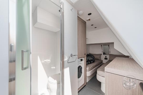 Interior of 2025 Sunseeker Manhattan 68 yacht, featuring modern bathroom and cozy cabin space.