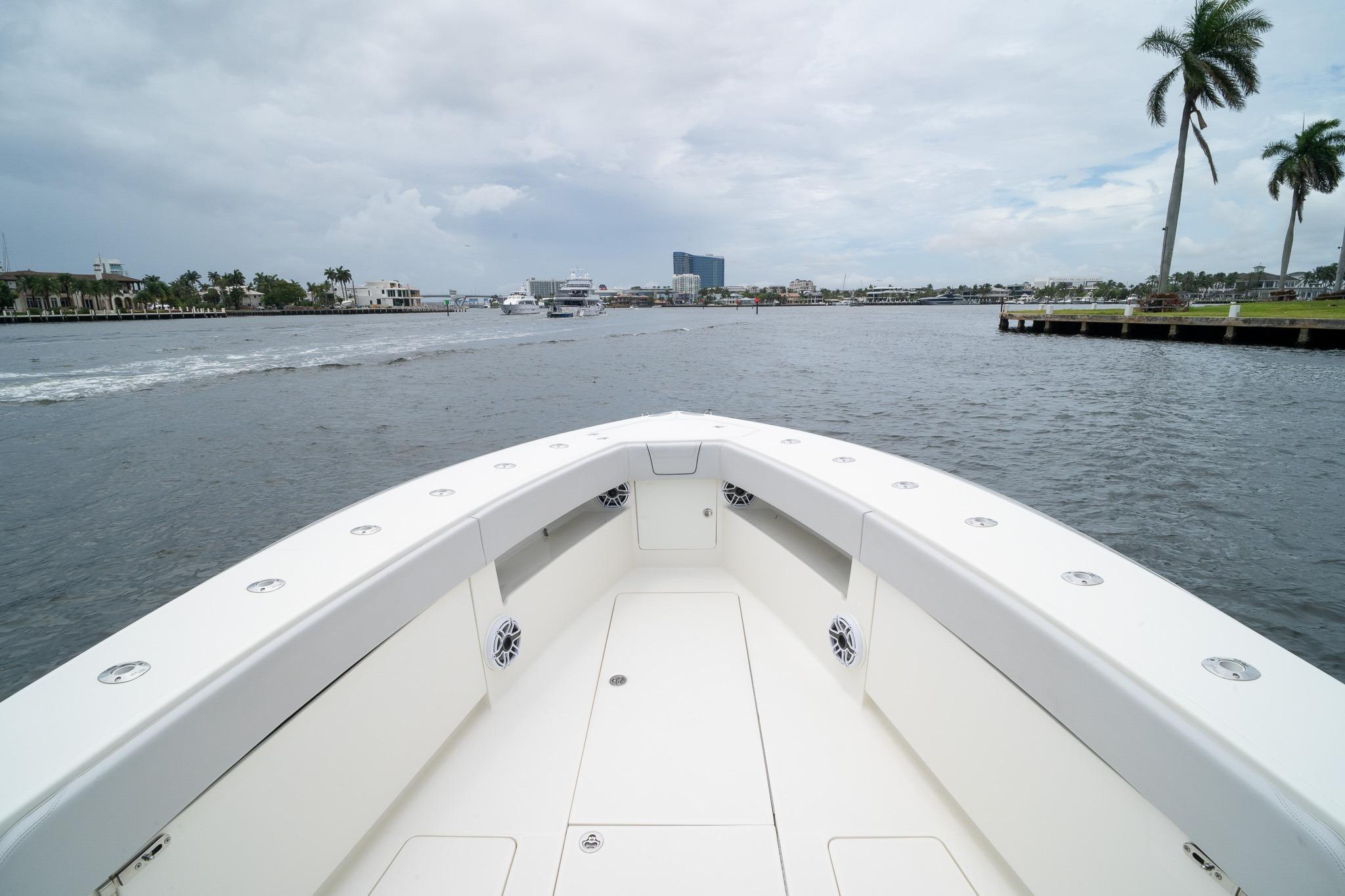Bow view of 2018 SeaVee 390Z boat on a calm waterway with palm trees.
