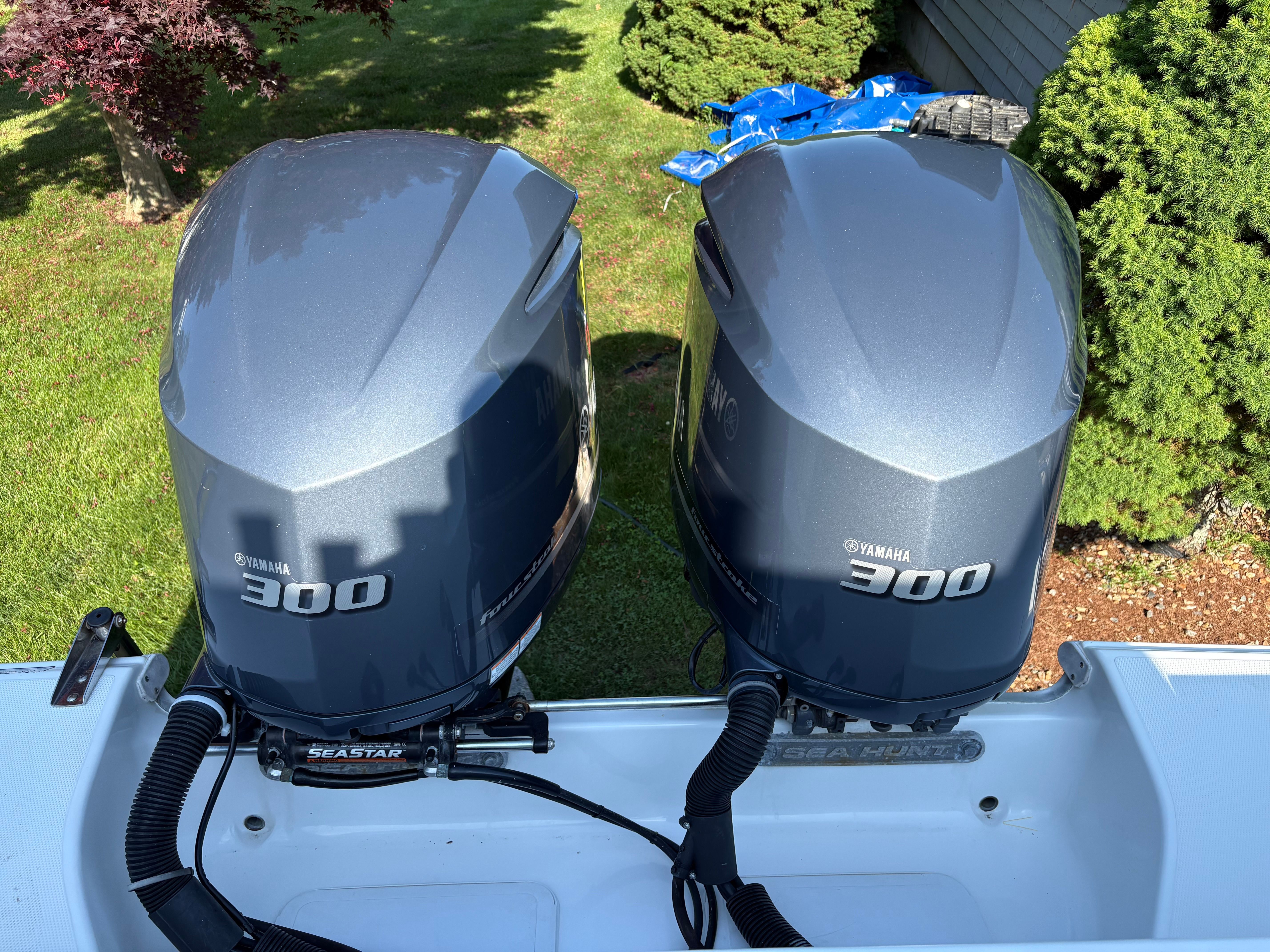 Two Yamaha 300 outboard engines are mounted on the stern of a Sea Hunt Gamefish 29 boat.