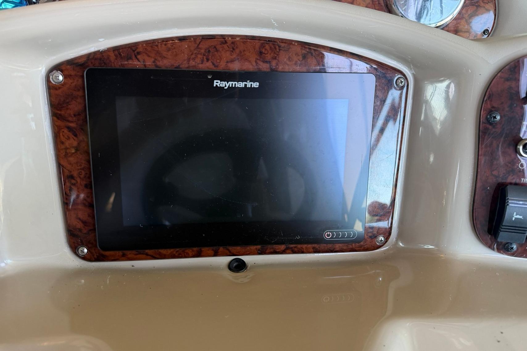 Raymarine display on 2006 Sea Ray Sundancer 320 dashboard with wood trim.
