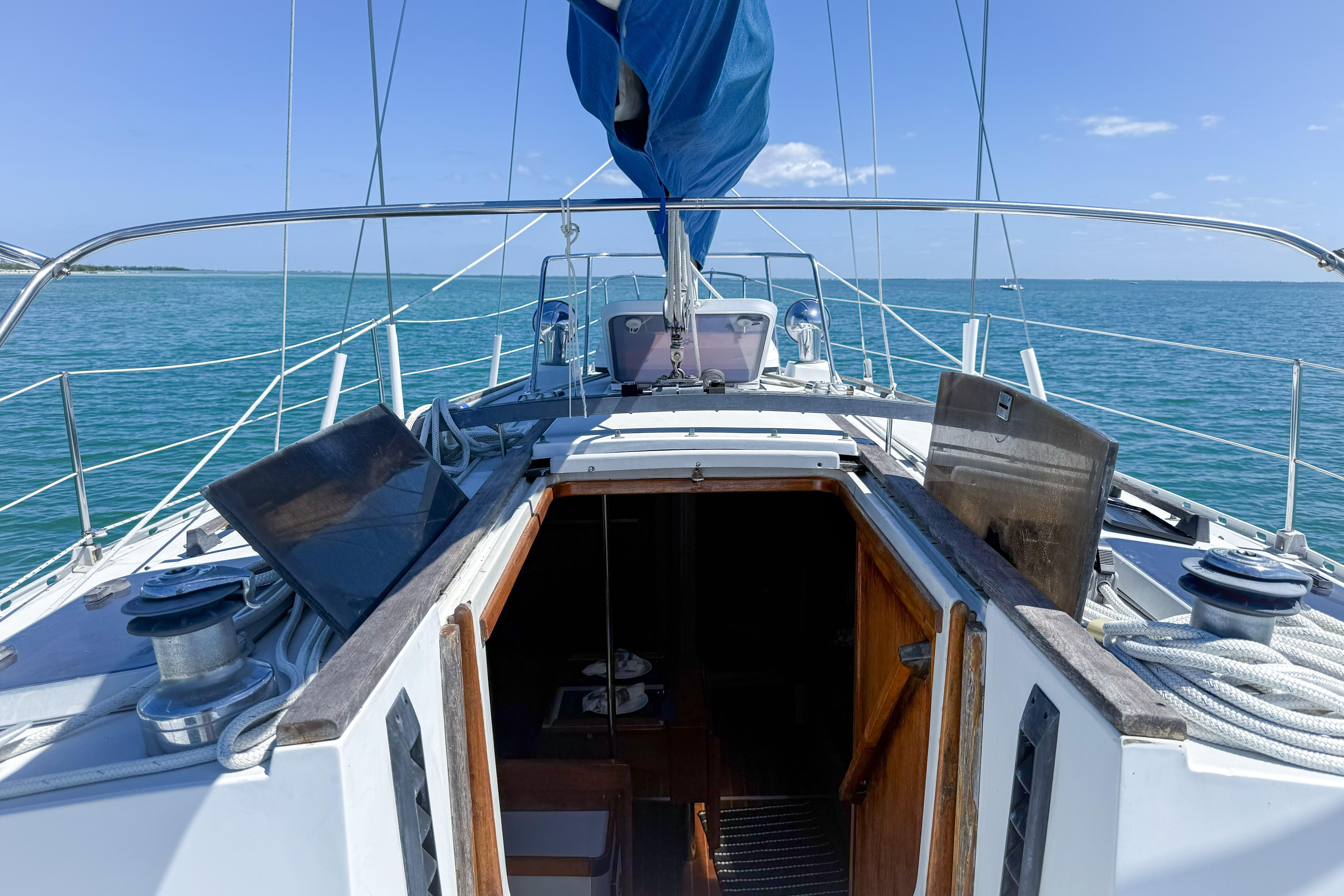 1988 Oday 40 sailboat deck with open cabin, sailing on calm blue waters.