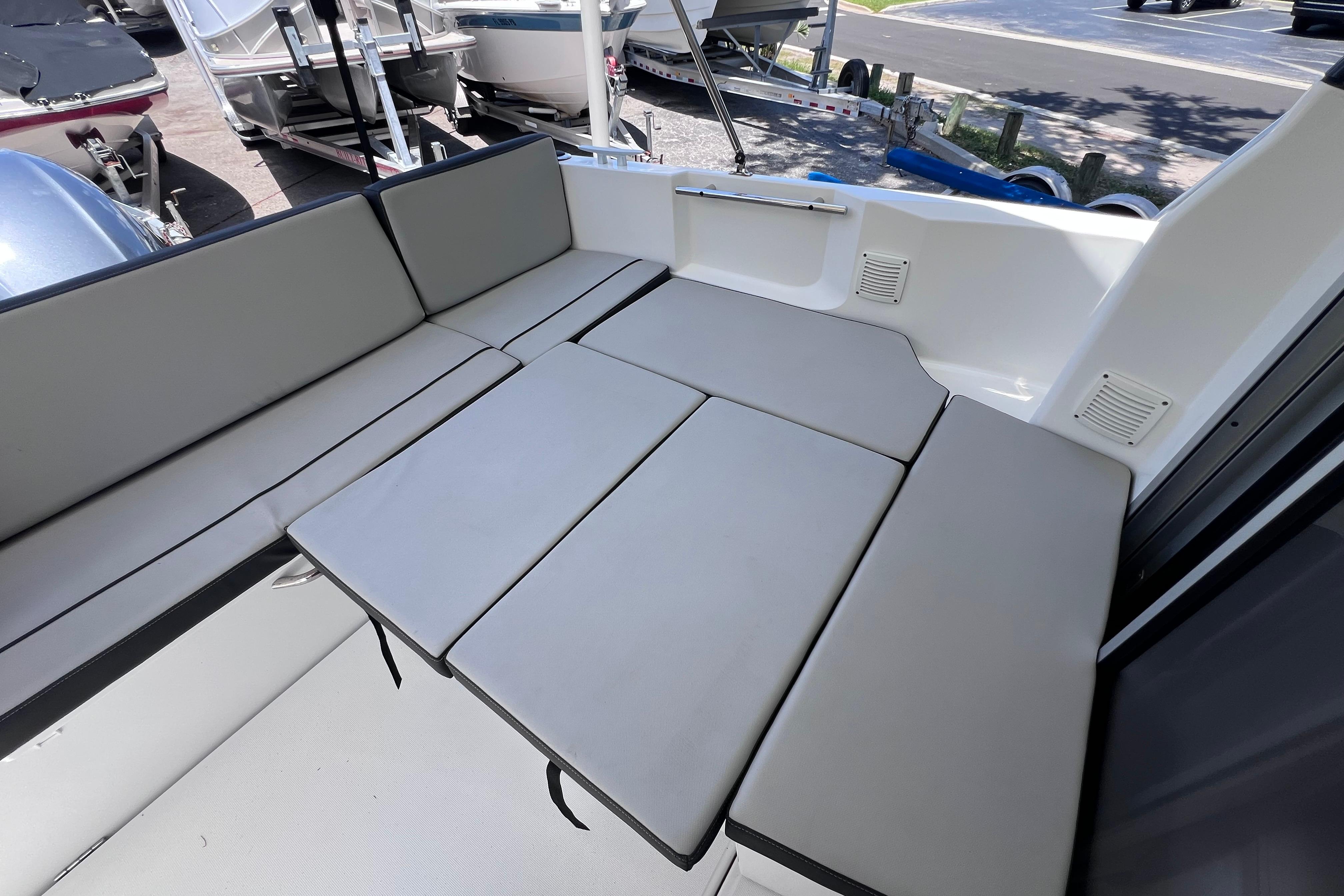 2021 Jeanneau NC Weekender 795 Series 2 boat seating area with gray cushions.