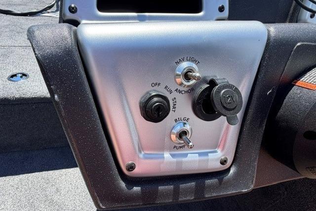 Control panel of 2026 Tracker Pro Team 175 Crappie Edition boat with switches and 12V outlet.