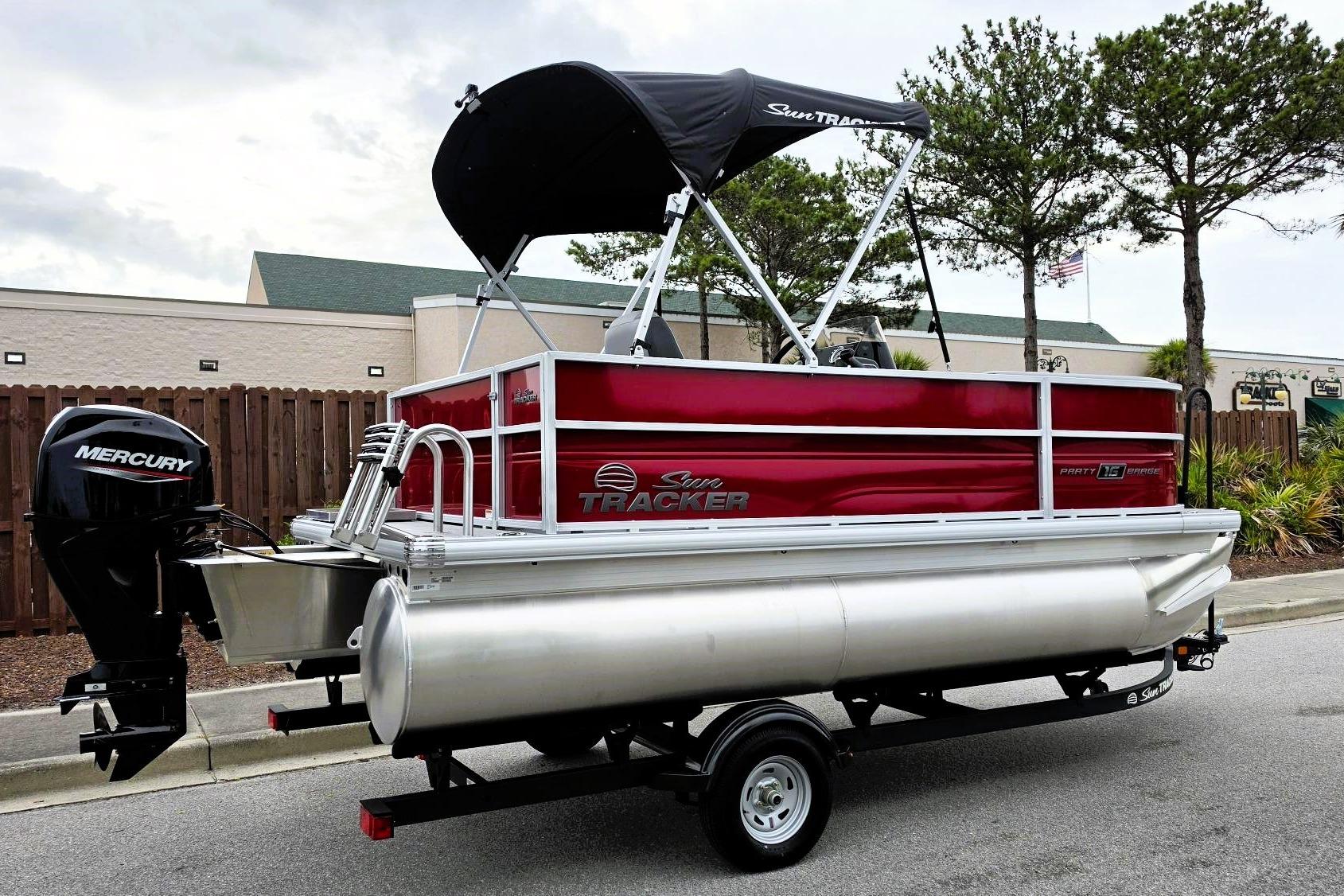 2026 Sun Tracker Party Barge 16 DLX pontoon boat with Mercury engine on trailer.