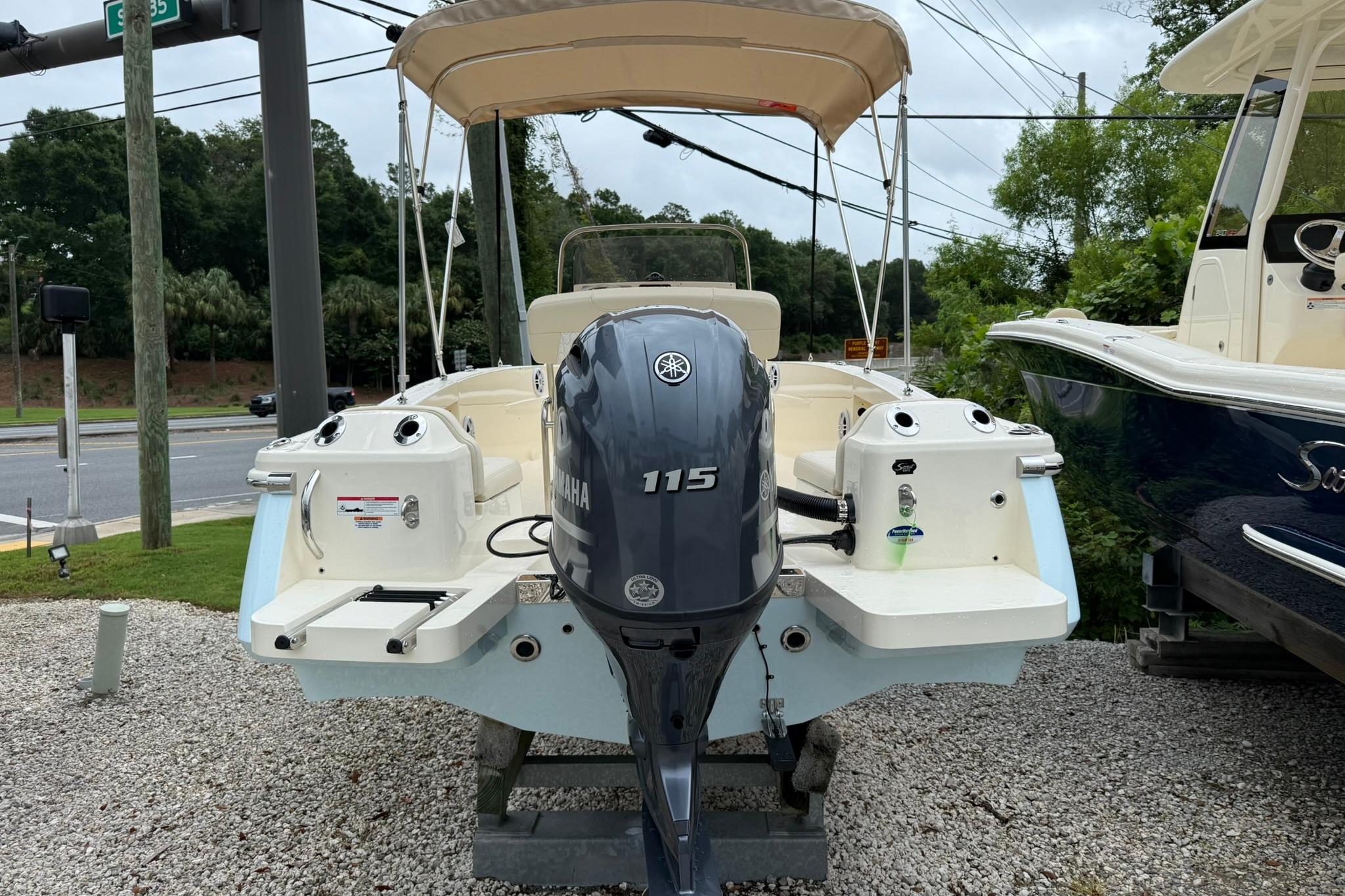 2027 Scout 188 Sportfish boat with Yamaha 115 engine, parked on gravel.