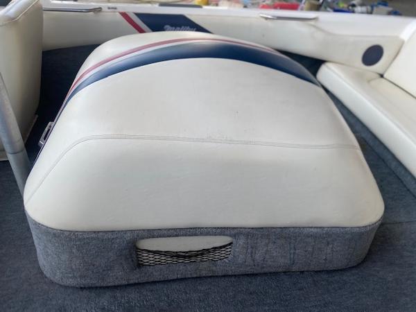 1998 Malibu Response boat interior with white and blue cushioned seating.