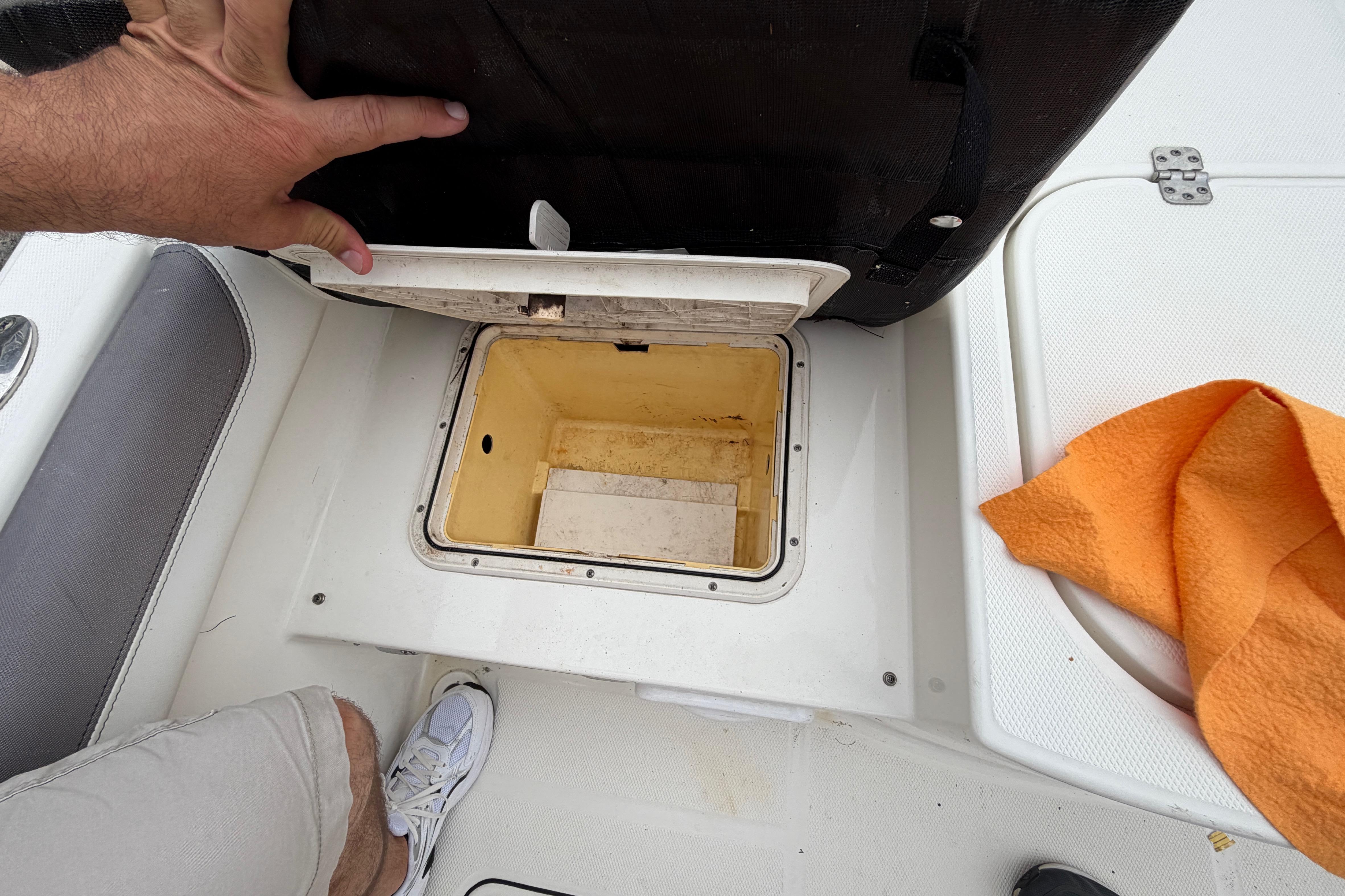 Open storage compartment on a 2019 World Cat 230 DC boat deck.