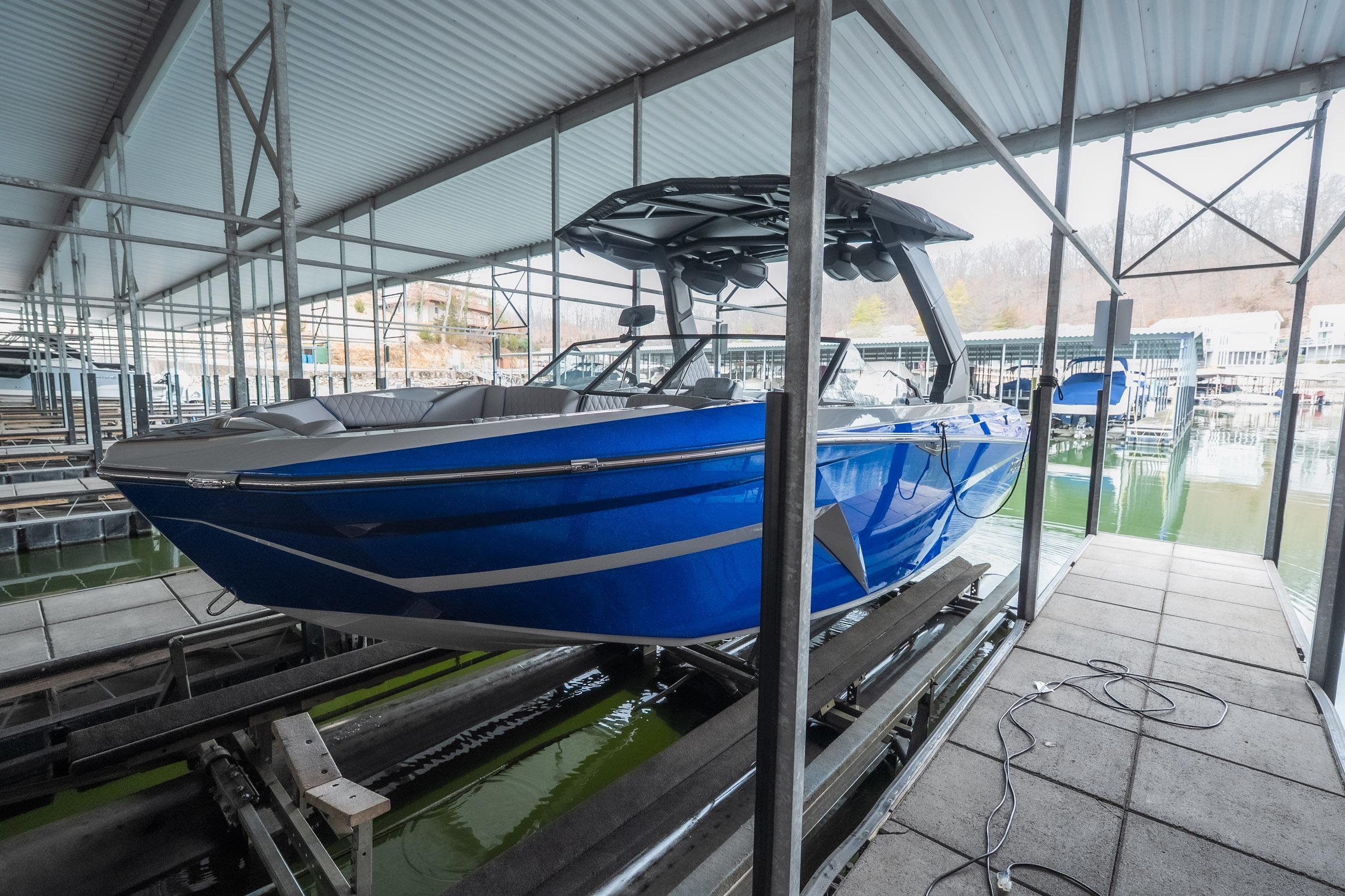 2026 Tigé Z3 boat in blue, docked in a covered marina.