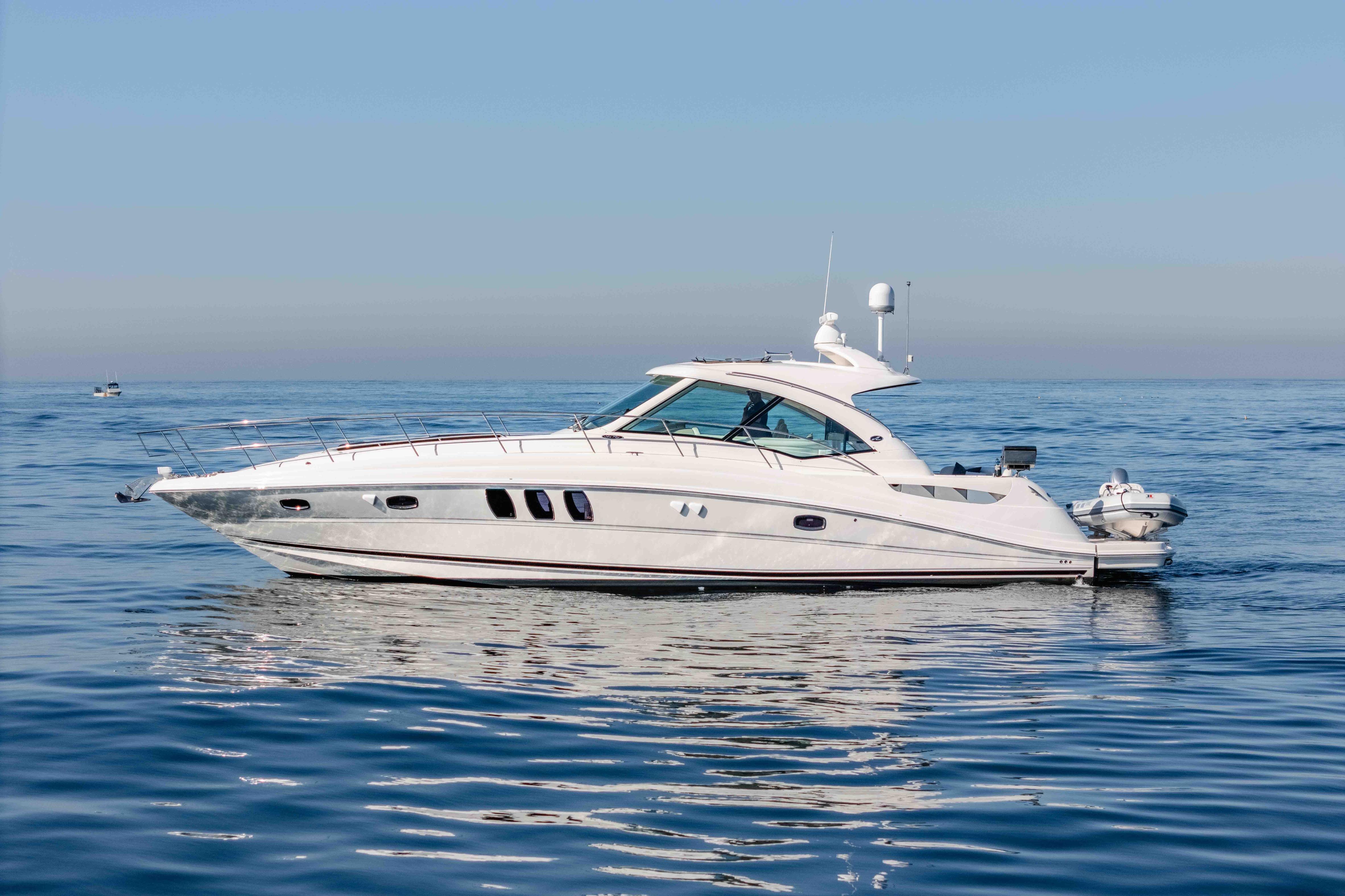 2007 Sea Ray 48 Sundancer yacht cruising on calm blue waters.