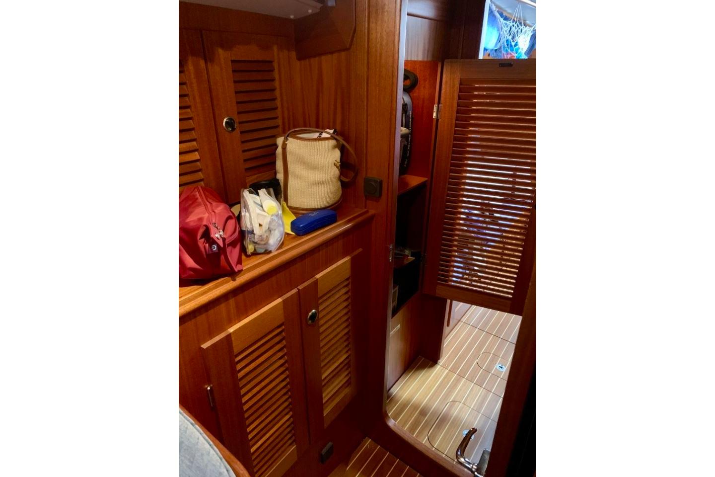Interior of 1997 Hallberg-Rassy 39 sailboat with wooden cabinetry and storage.