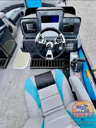 2024 Massimo Marine T-25 Ultra Lounger boat cockpit with modern controls and plush seating.