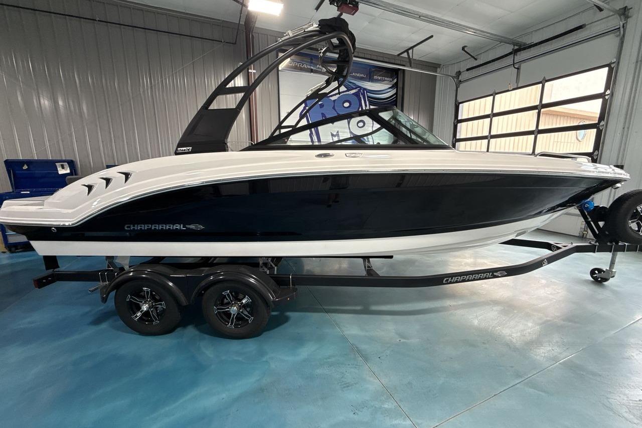 Chaparral 23 SSi 2026 on a trailer in a showroom.