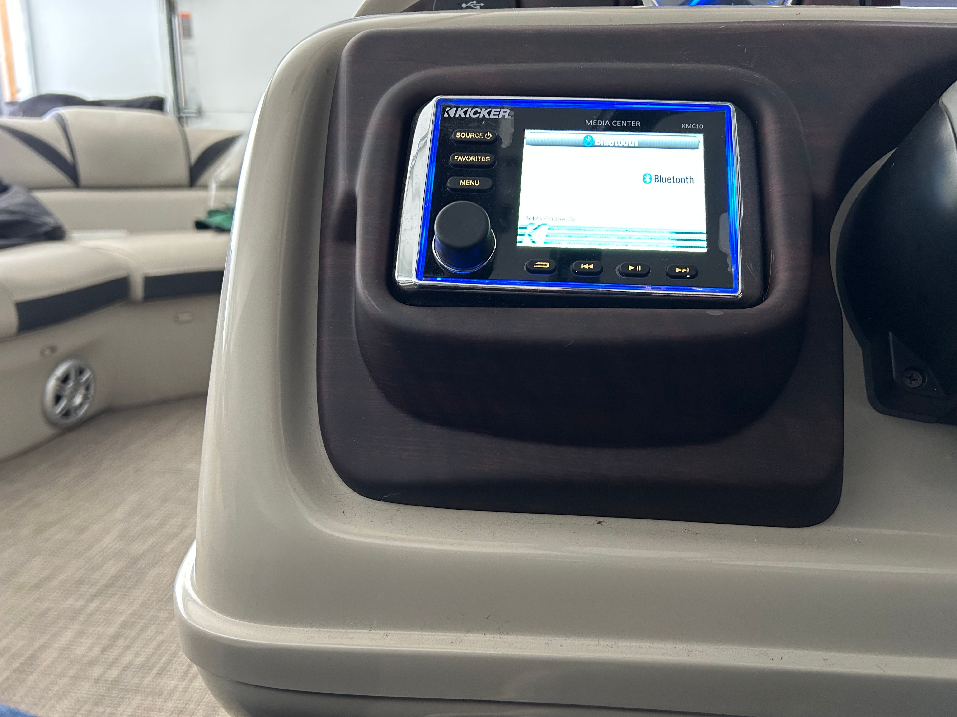 Close-up of a boat console area with a Kicker audio system.