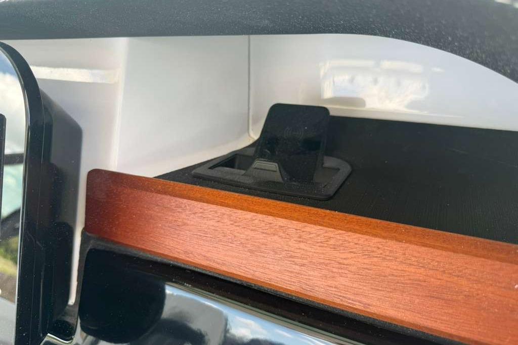 Interior detail of 2026 Monterey Elite 30 OB, featuring sleek wood and black accents.