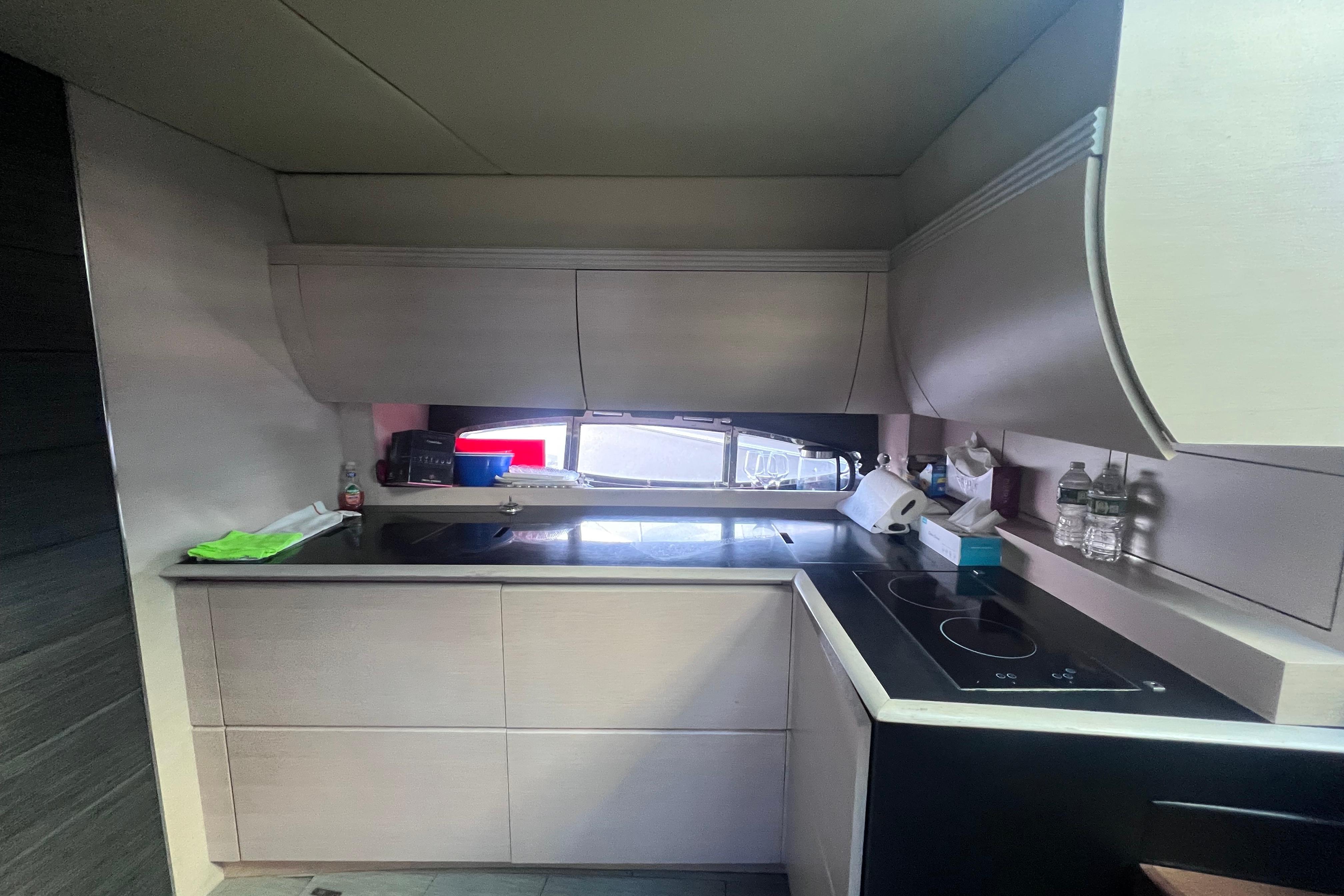 Modern kitchen interior on a 2006 Azimut Atlantis 55 yacht, featuring sleek cabinetry and appliances.