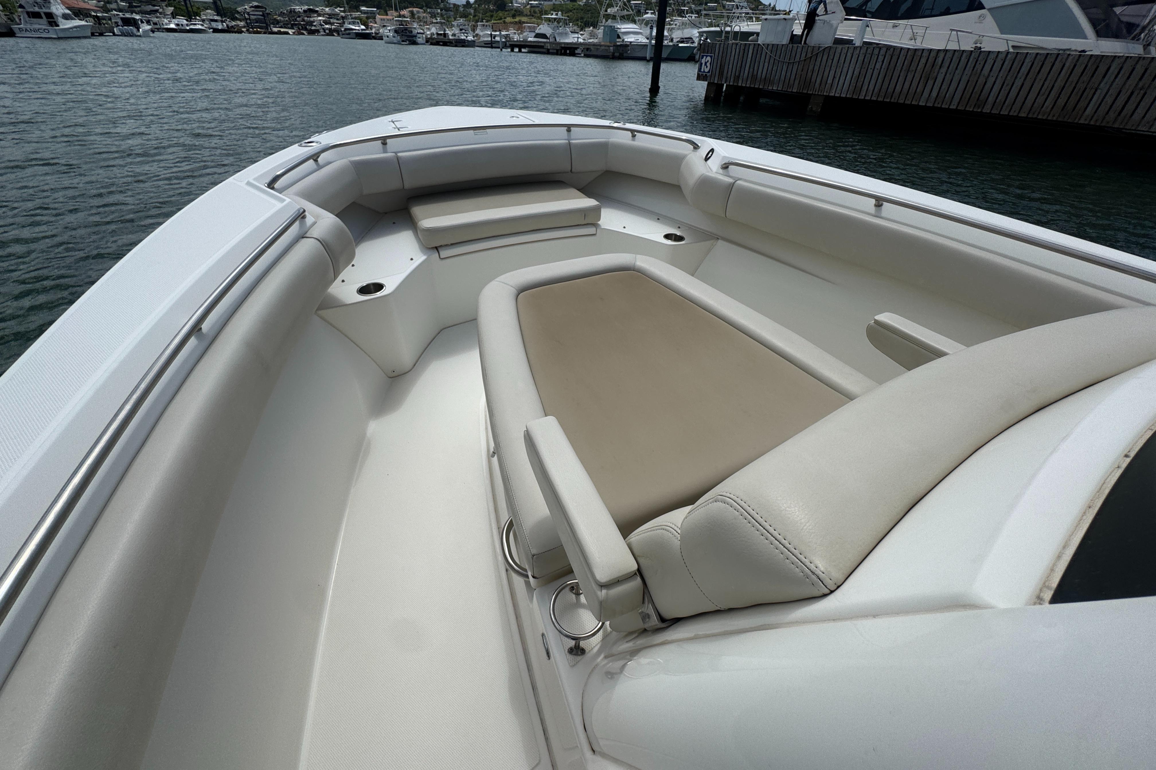 2022 Boston Whaler 280 Outrage boat interior with beige seating and spacious layout.