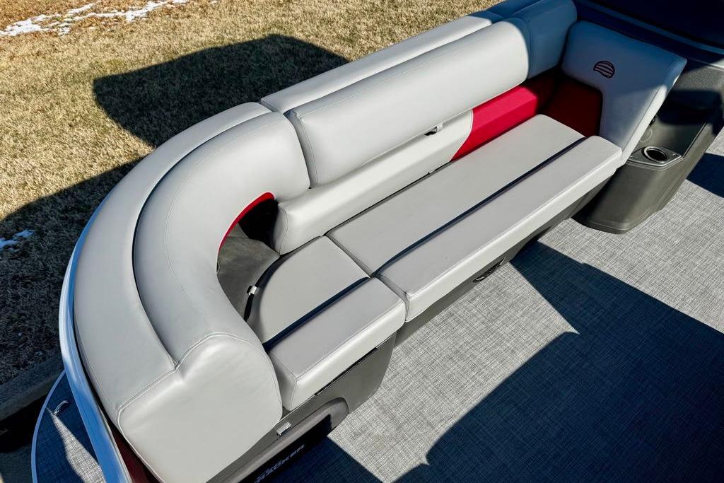 2026 Sun Tracker Party Barge 20 DLX pontoon boat with gray seating and red accents.