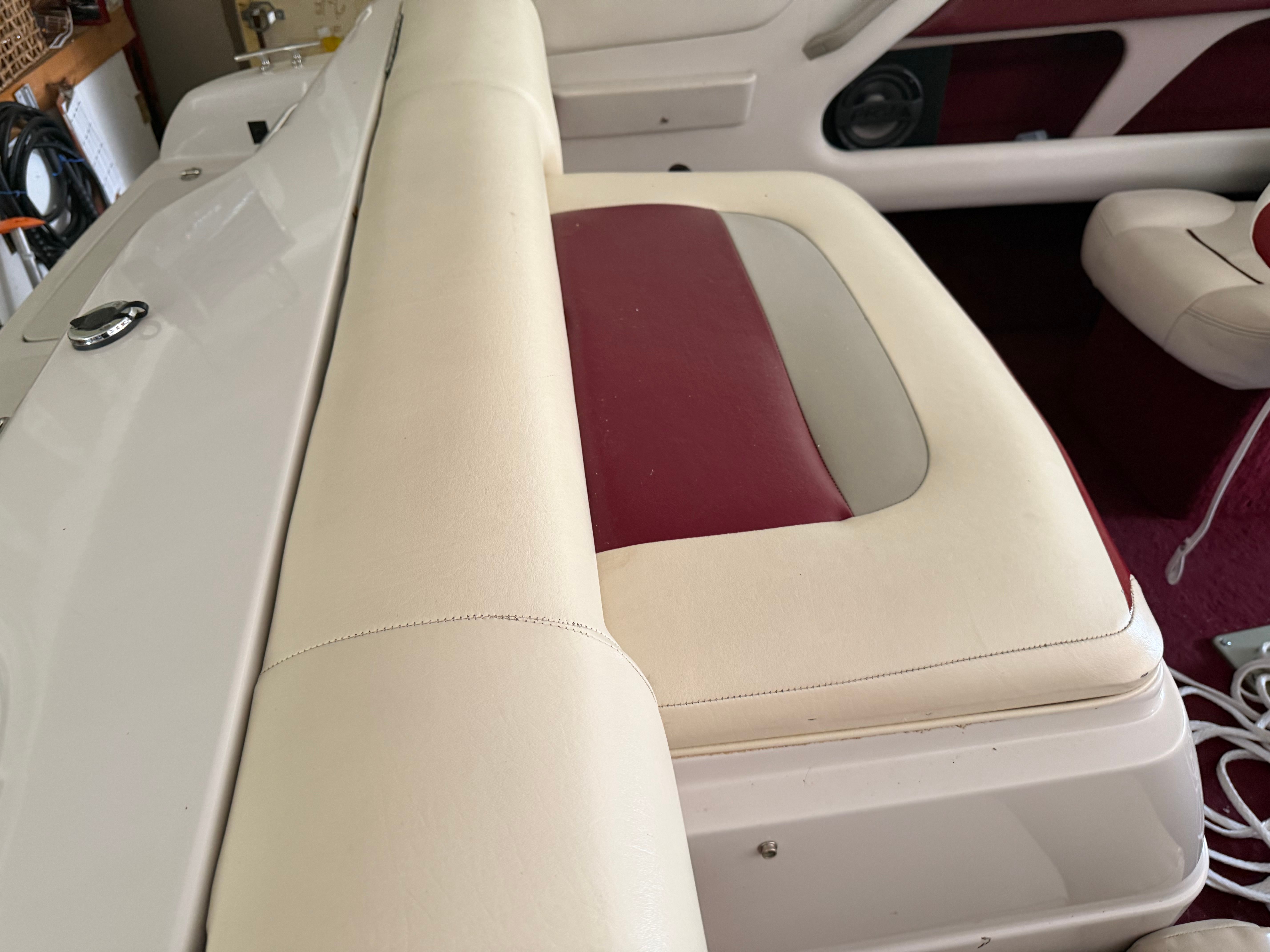 Interior of a 1994 Chaparral 1930 with cream and maroon upholstery.