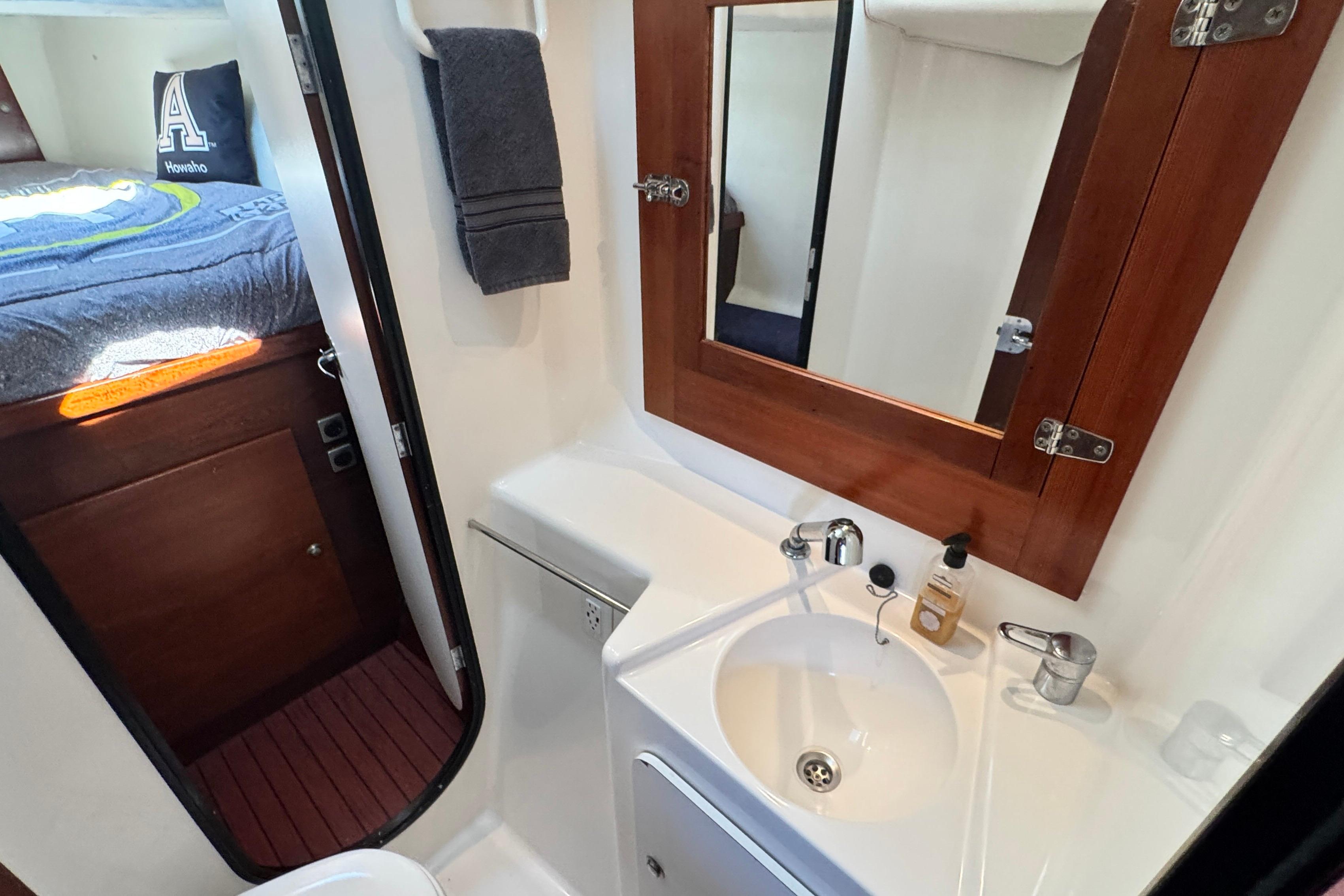 Bathroom interior of 2005 Fountaine Pajot Maryland 37 yacht with sink and mirror.