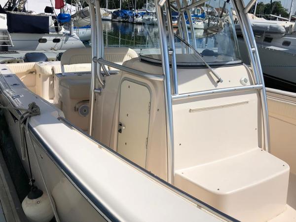 2006 Grady-White Bimini 306 boat docked in marina, featuring spacious deck and sleek design.