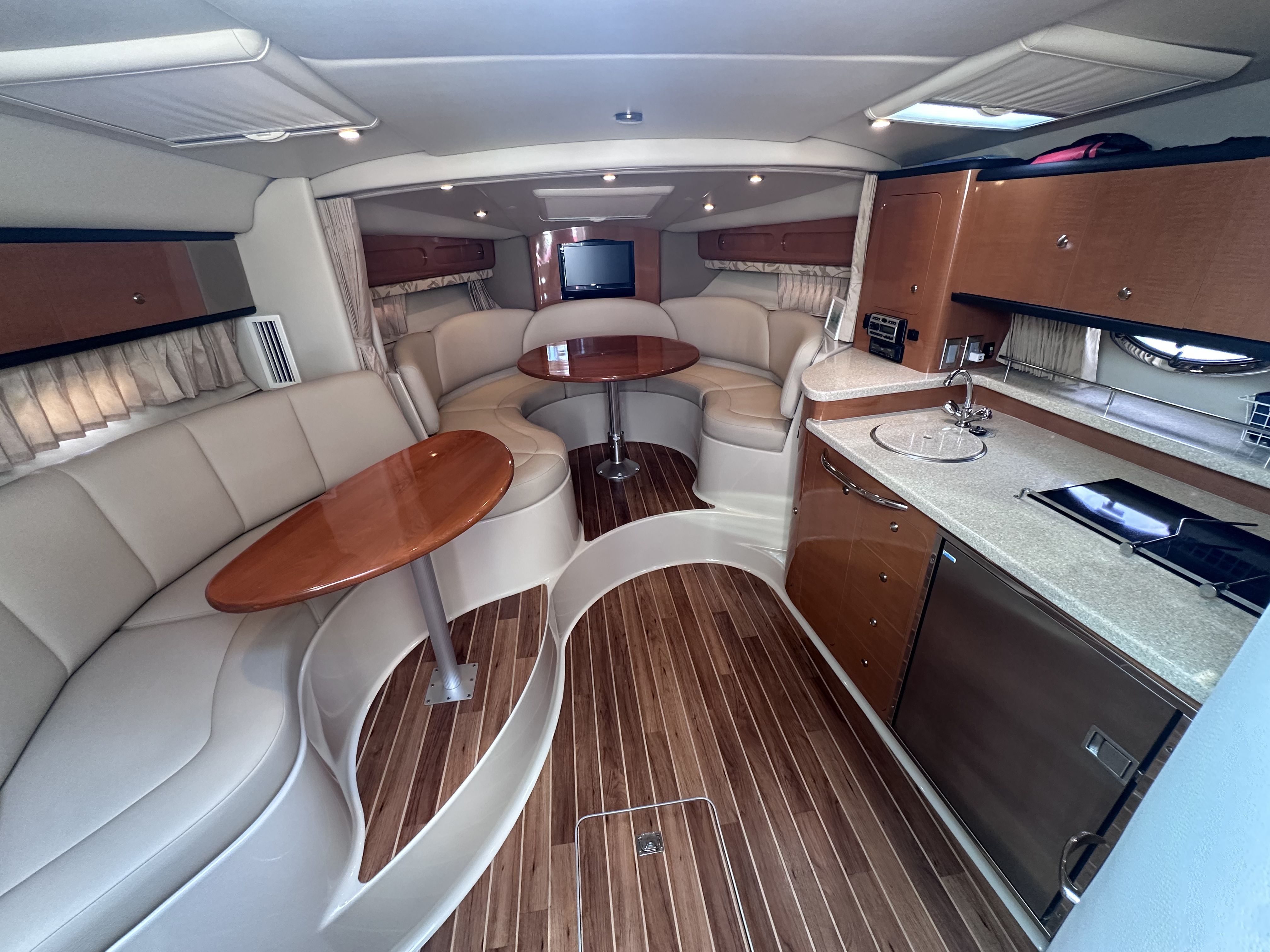 Interior of the 2008 Chaparral Signature 330 with elegant seating area and kitchenette.