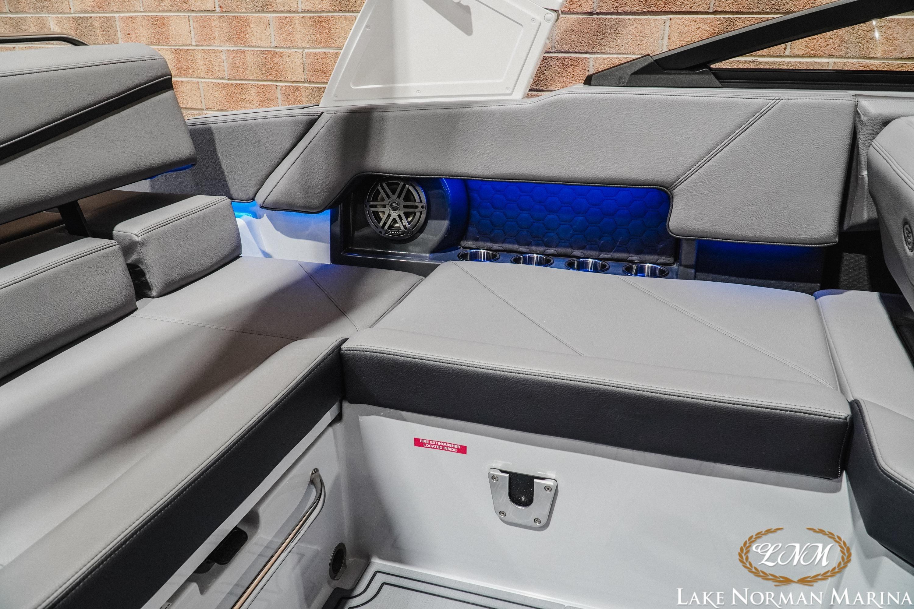 2026 Cobalt R4 Surf boat interior with gray seating and blue LED lighting.