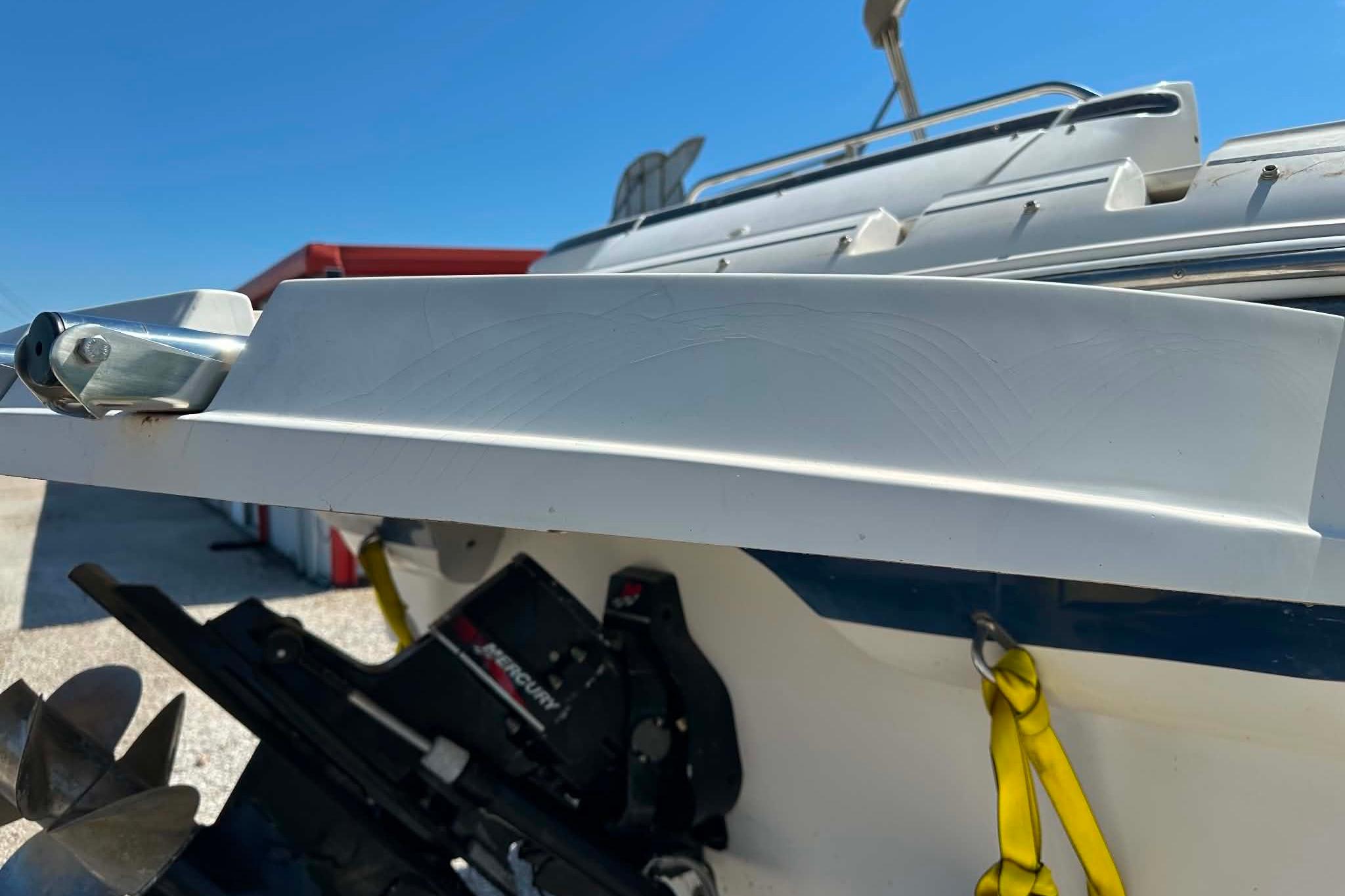 Rear view of a 2001 Monterey 248LS Montura Bowrider boat with visible propeller and hardware.