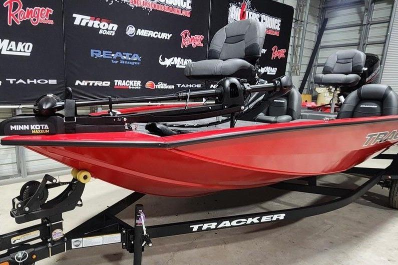 2026 Tracker Pro Team 175 boat in showroom, featuring Minn Kota Maxxum motor.