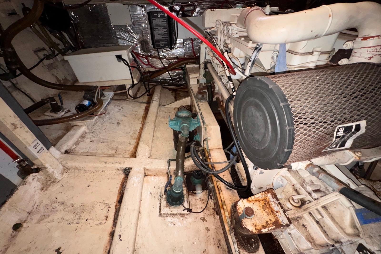 Engine room of a 1995 Island Gypsy Eurosedan 32, showcasing mechanical components and wiring.