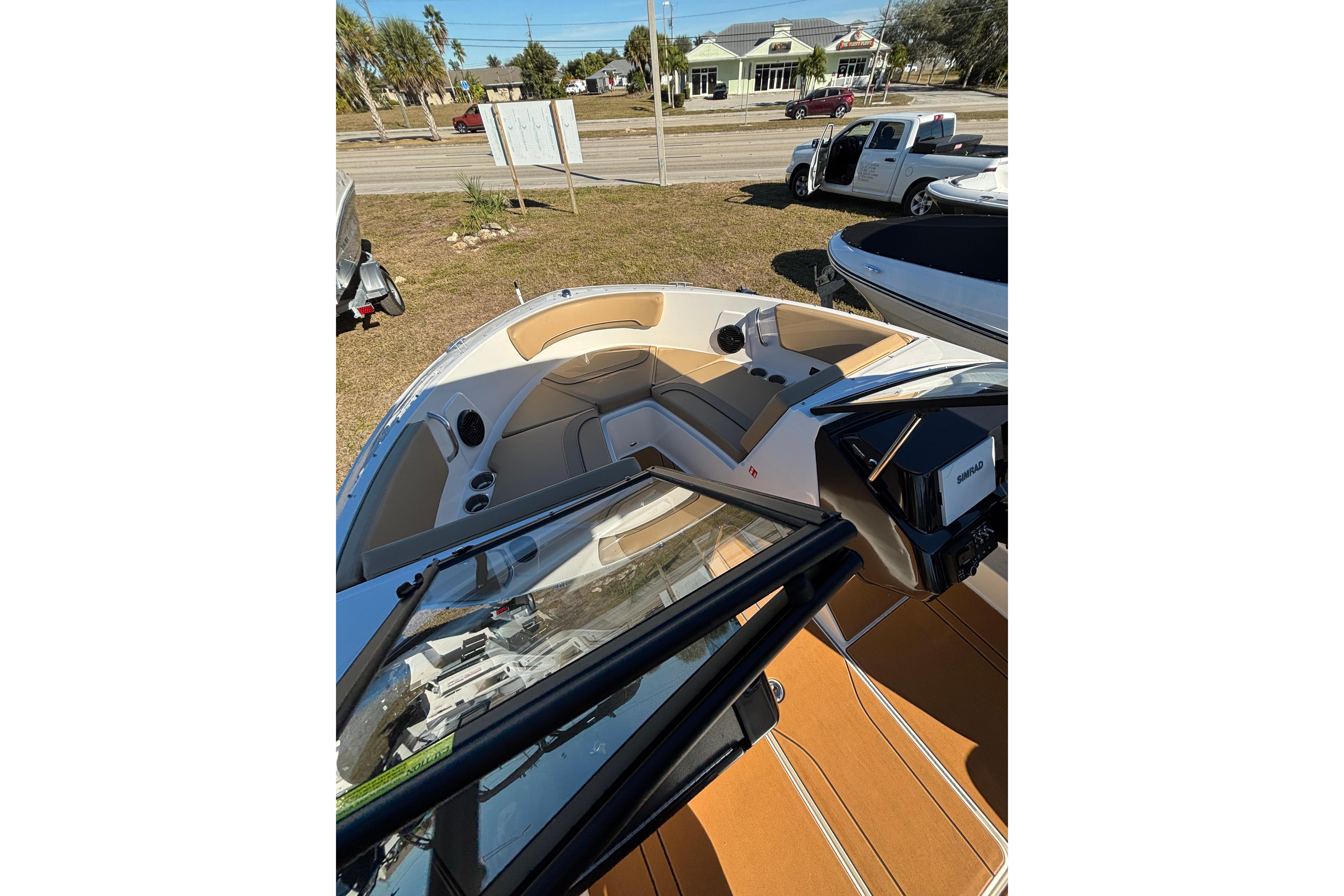 2025 Bayliner V20 boat interior with tan seating and modern dashboard.